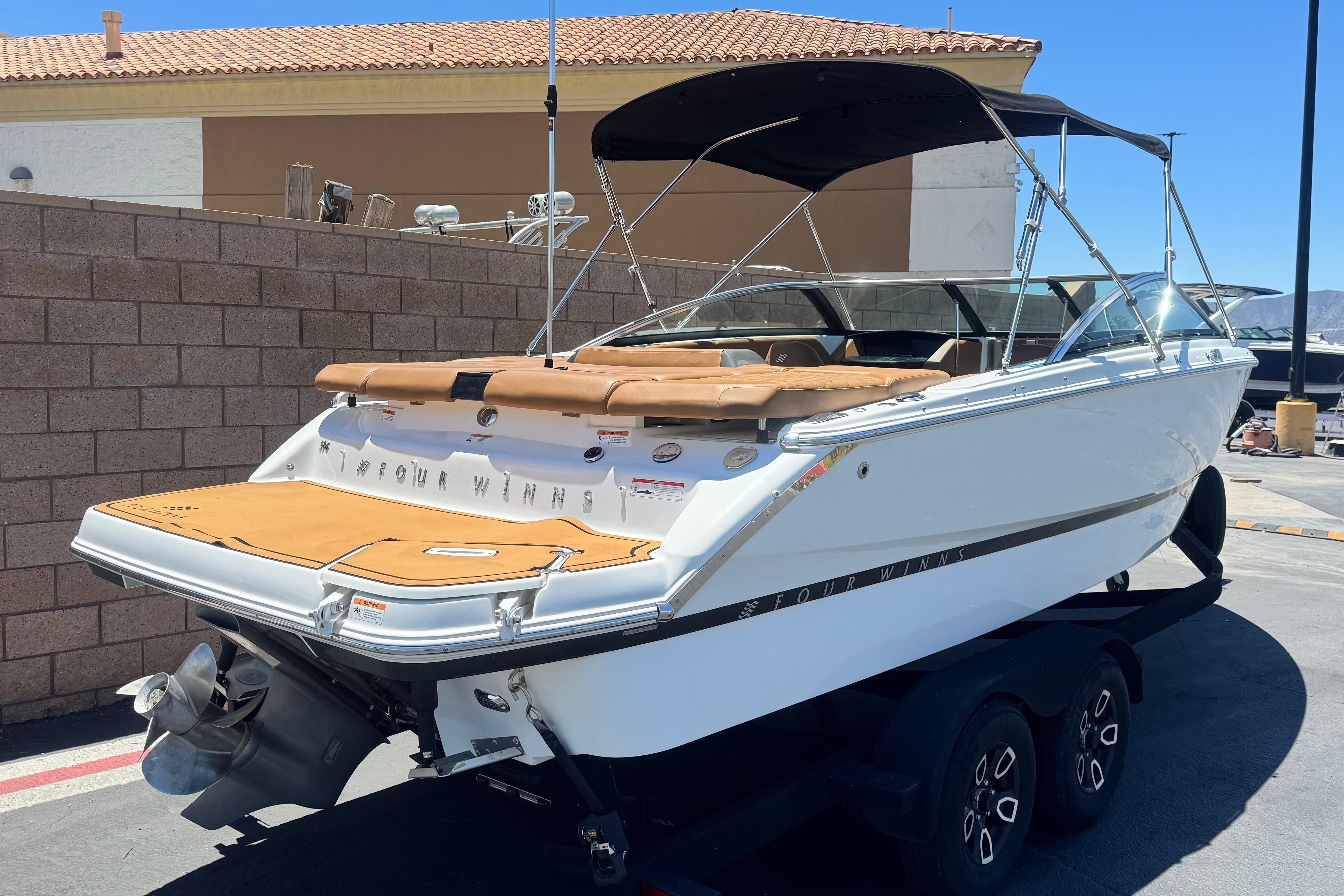 2022 Four Winns H4 boat on trailer, featuring sleek design and spacious seating.