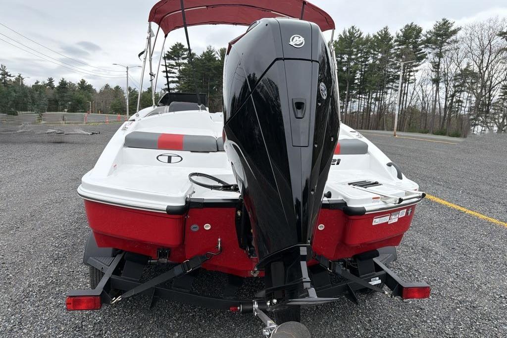 2026 Tahoe T21 boat with outboard motor on a trailer in a parking lot.