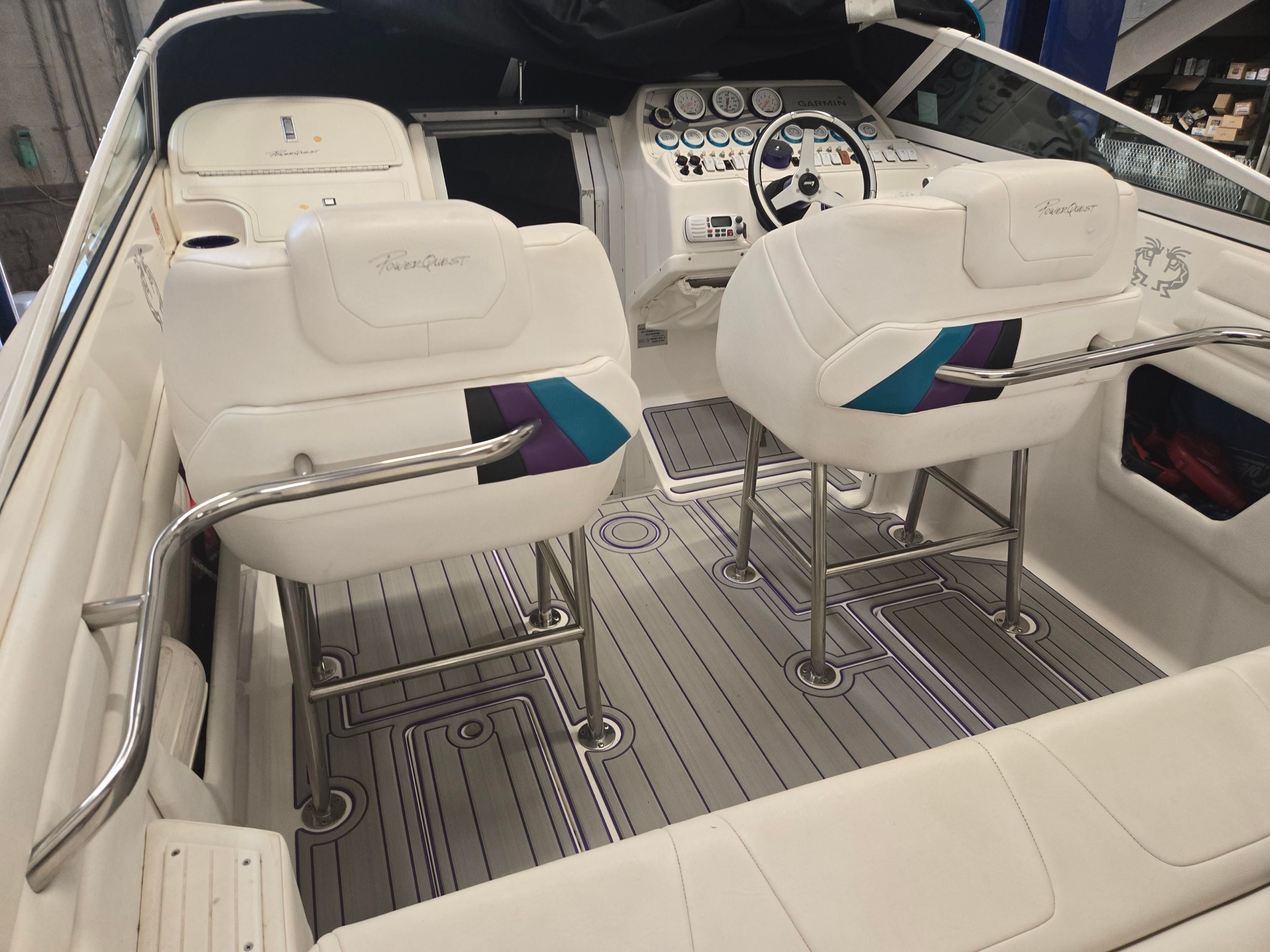 Interior of a 1998 Powerquest Enticer 290 FX with white seats and a modern dashboard.
