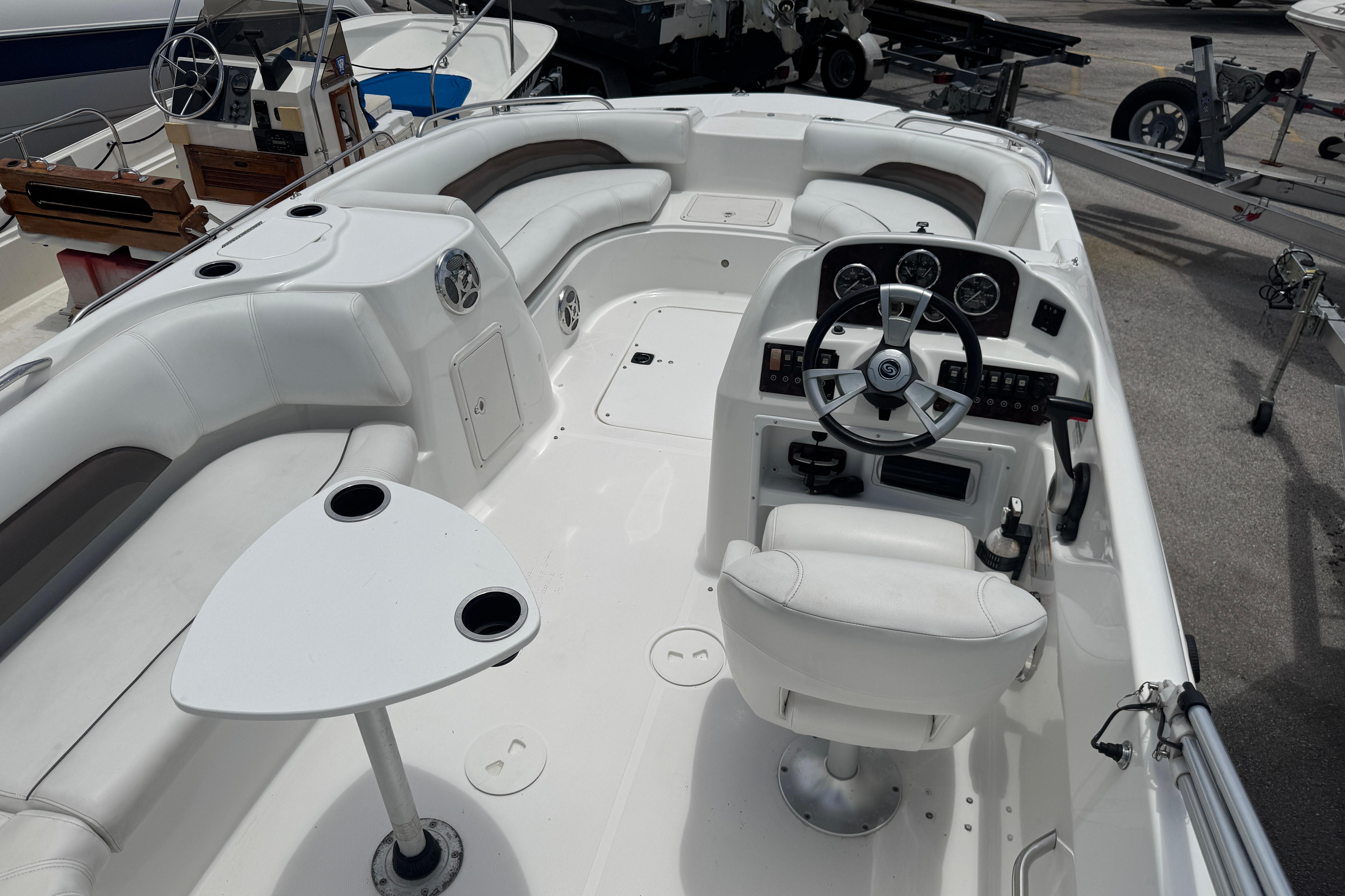 2013 Hurricane SunDeck Sport 188 OB boat interior with steering wheel and seating area.