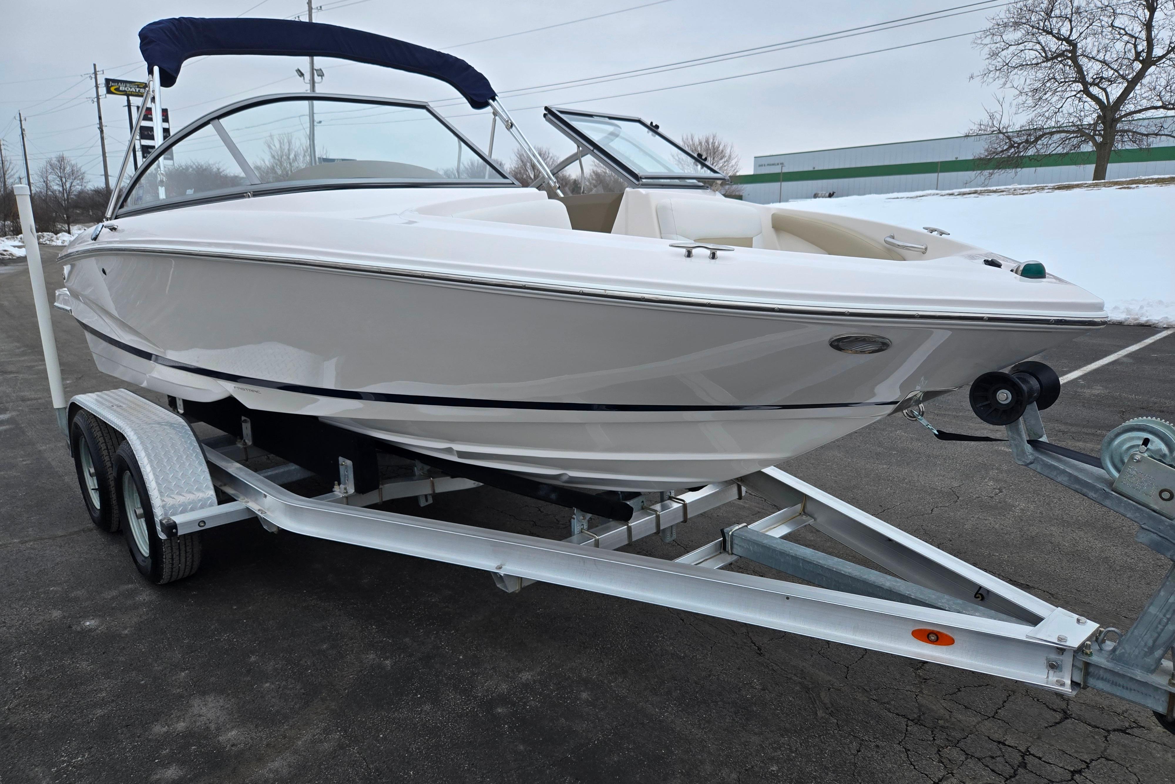 2015 Regal 1900 ES Bowrider on trailer, parked on snowy pavement.