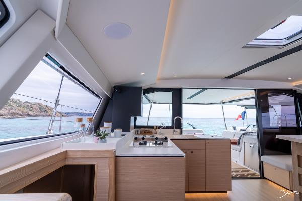 Luxurious interior of 2025 Nautitech 44 Open catamaran with modern kitchen and ocean view.