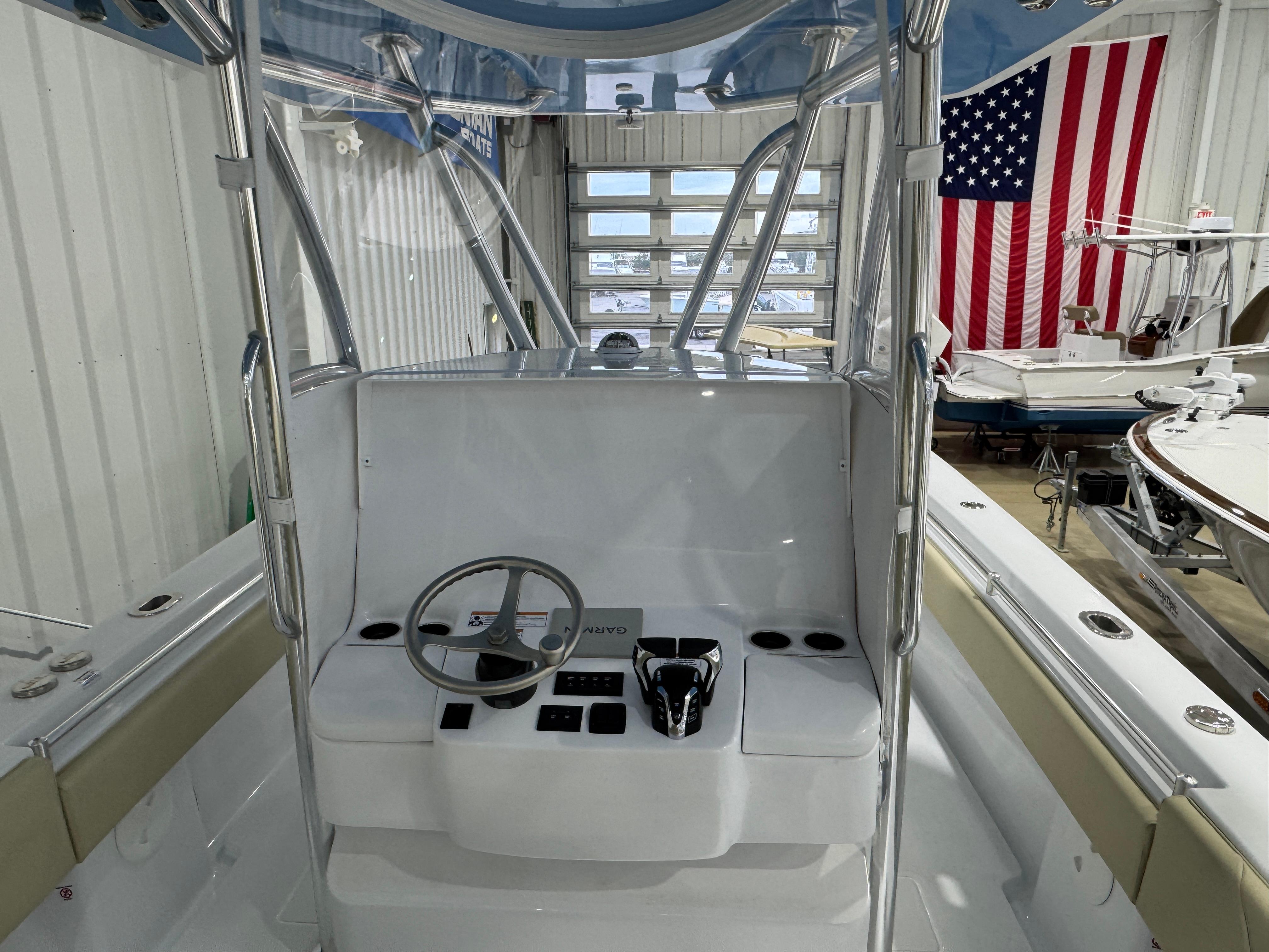 2025 Contender 32 ST boat interior with steering console in a showroom.
