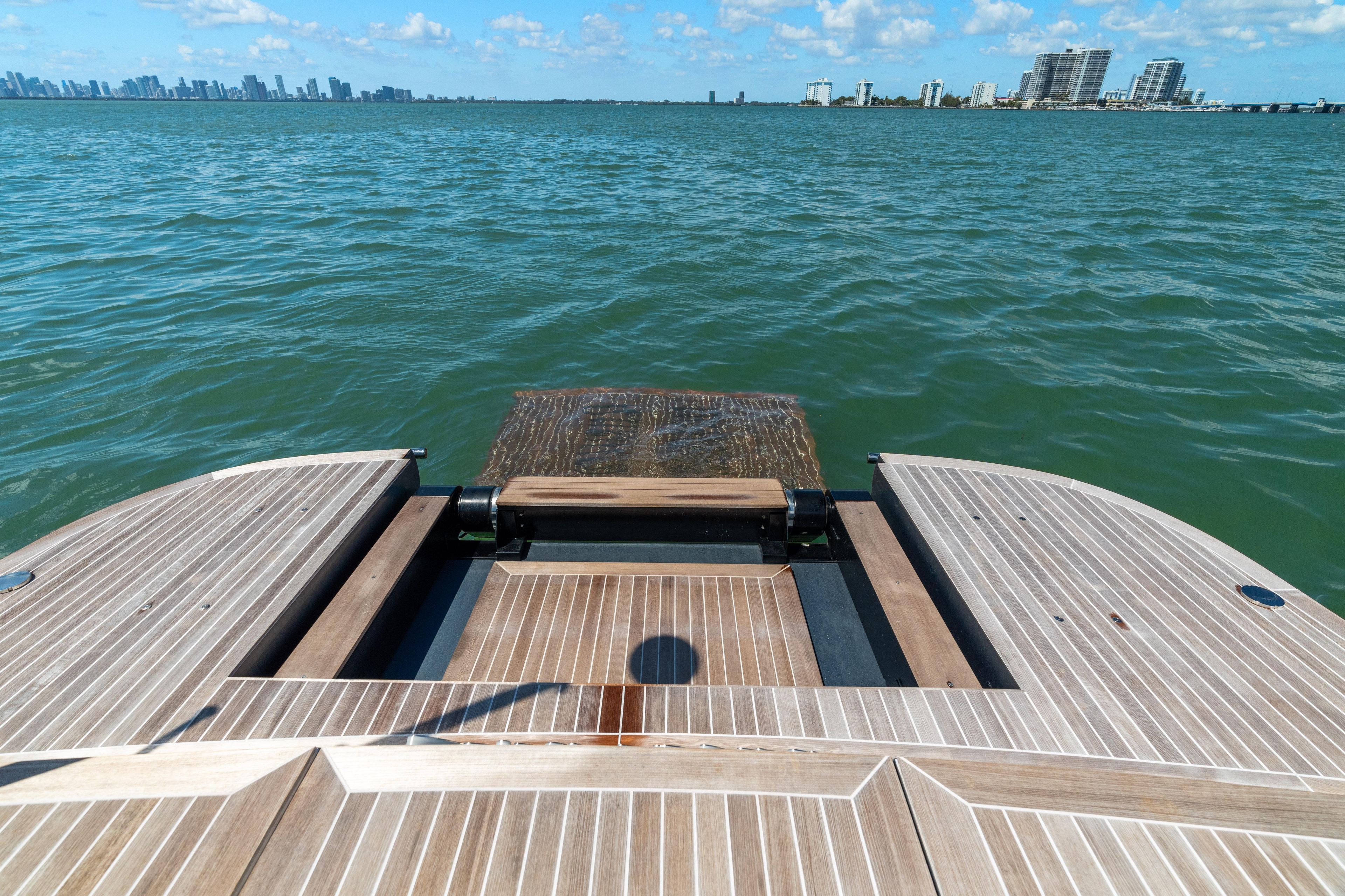 2024 CNM CONTINENTAL 54 SuperSport yacht deck overlooking ocean and city skyline.