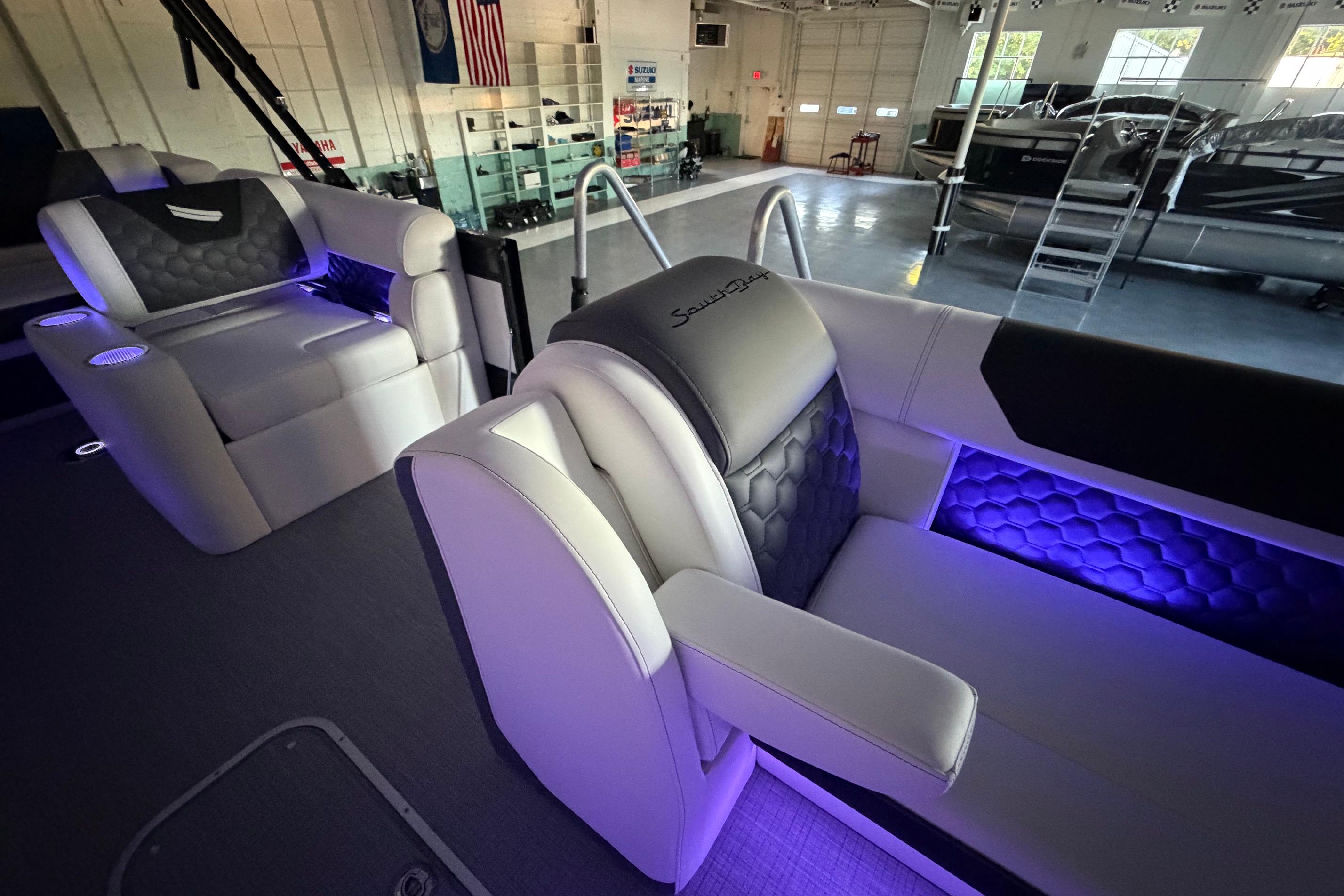 Luxurious interior of 2026 South Bay 525SB2 pontoon boat with ambient lighting.