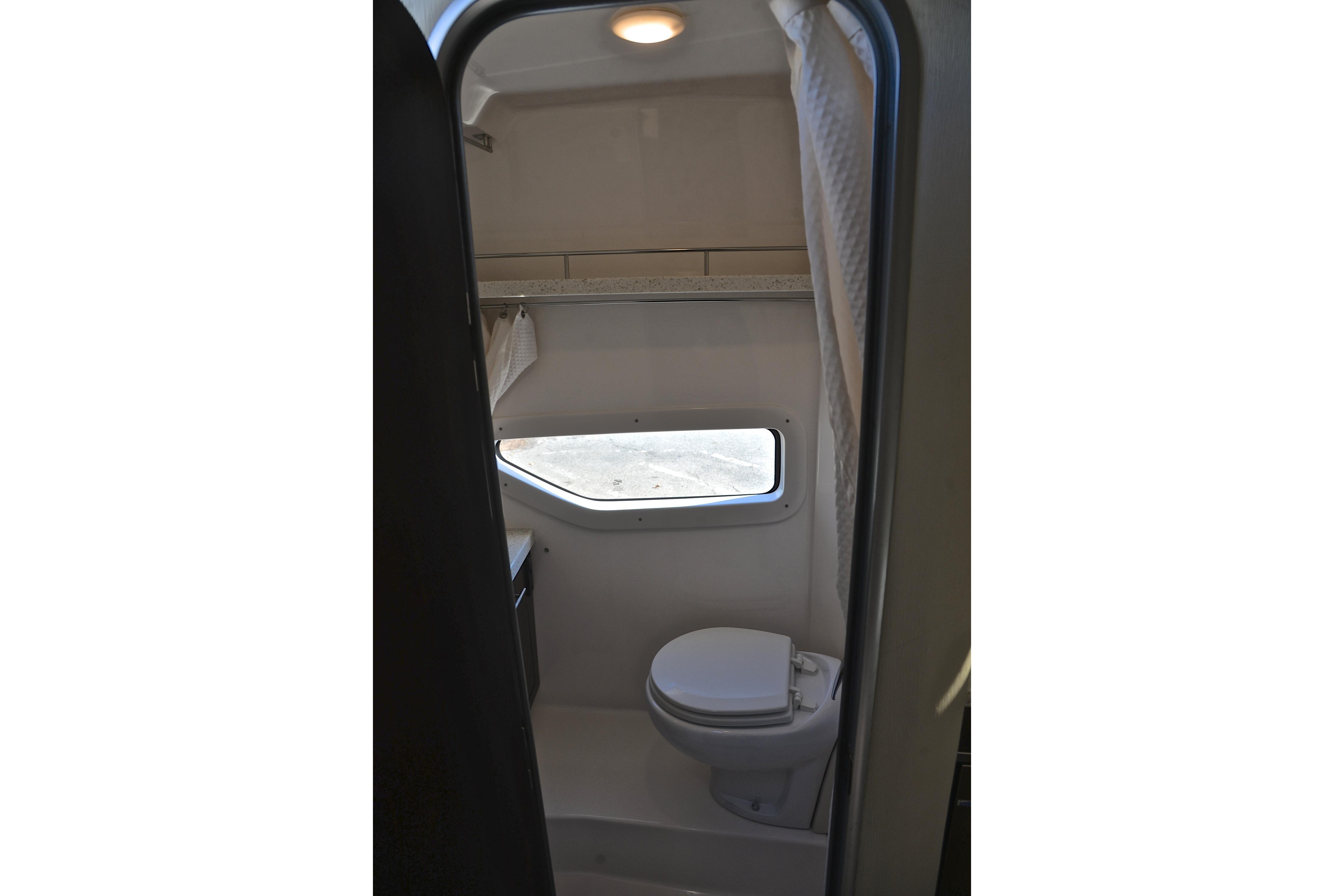 2018 Regal 33 Express boat bathroom interior with toilet and window.