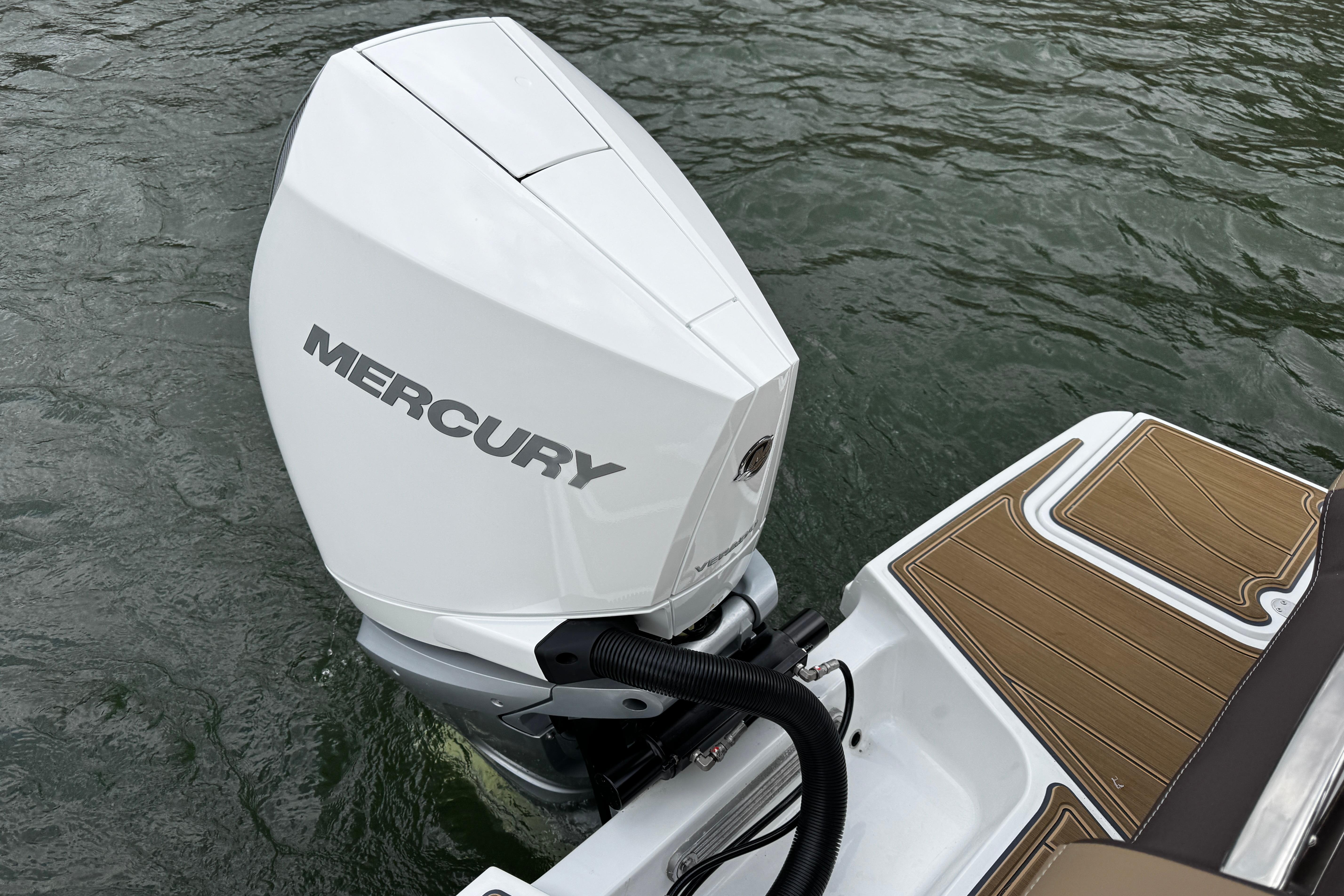 2026 Monterey Elite 25 OB with Mercury outboard engine on water.