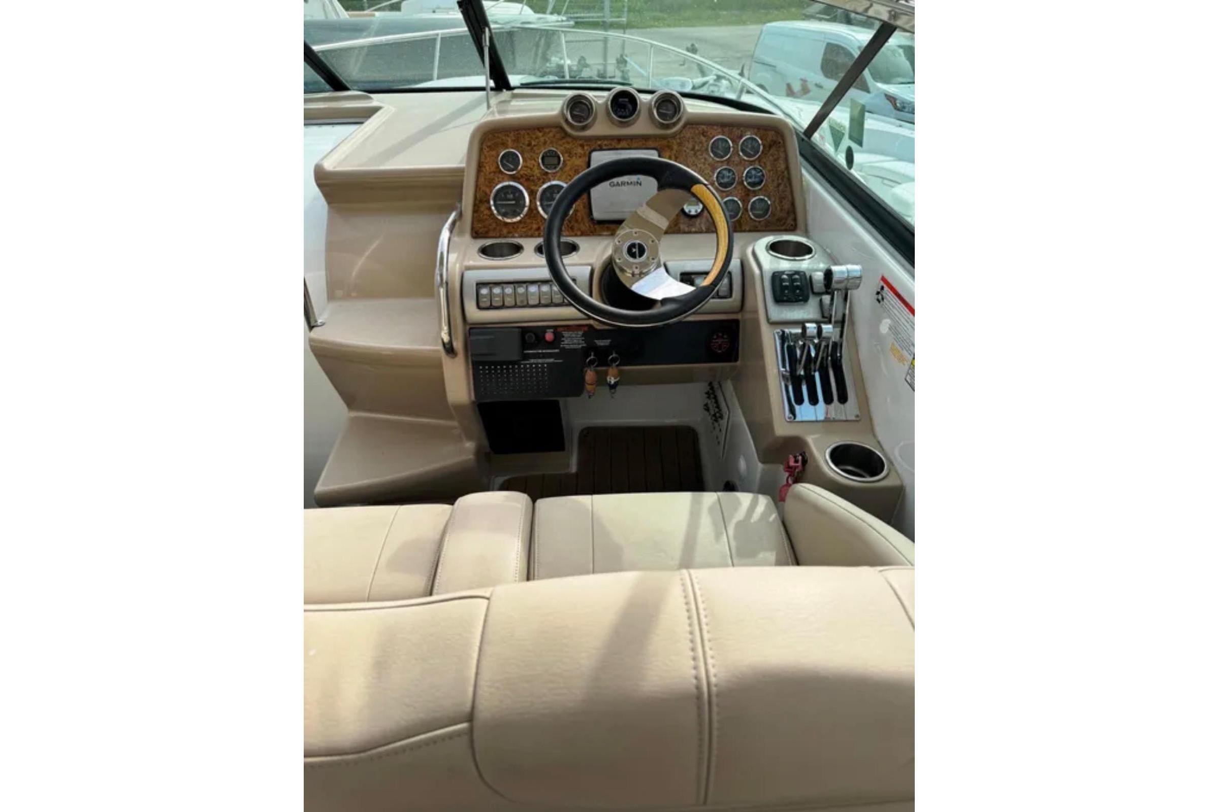 2010 Formula 310 Sun Sport boat cockpit with steering wheel and control panel.