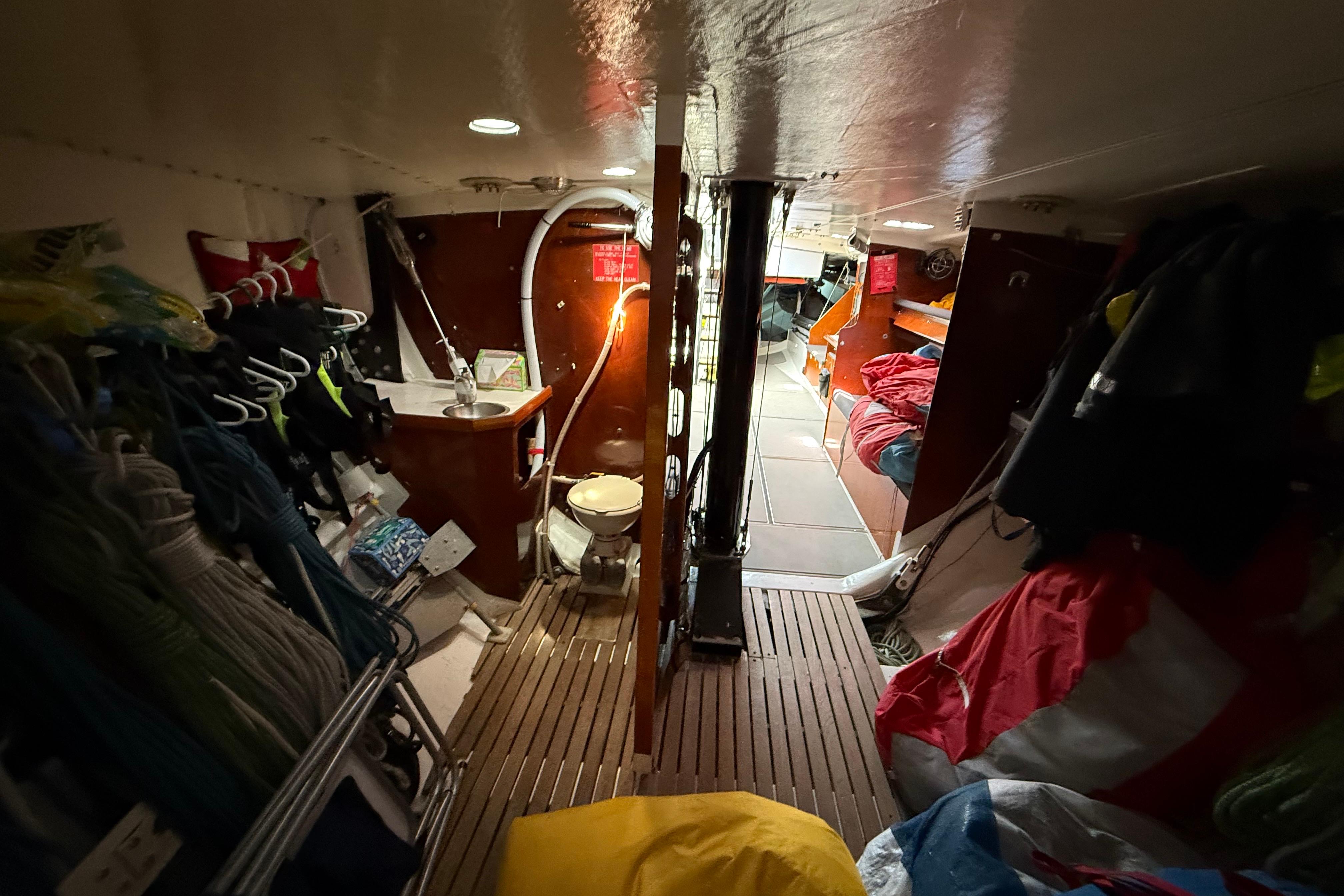 Interior of a 1987 Santa Cruz 70 sailboat with cozy living space and storage.