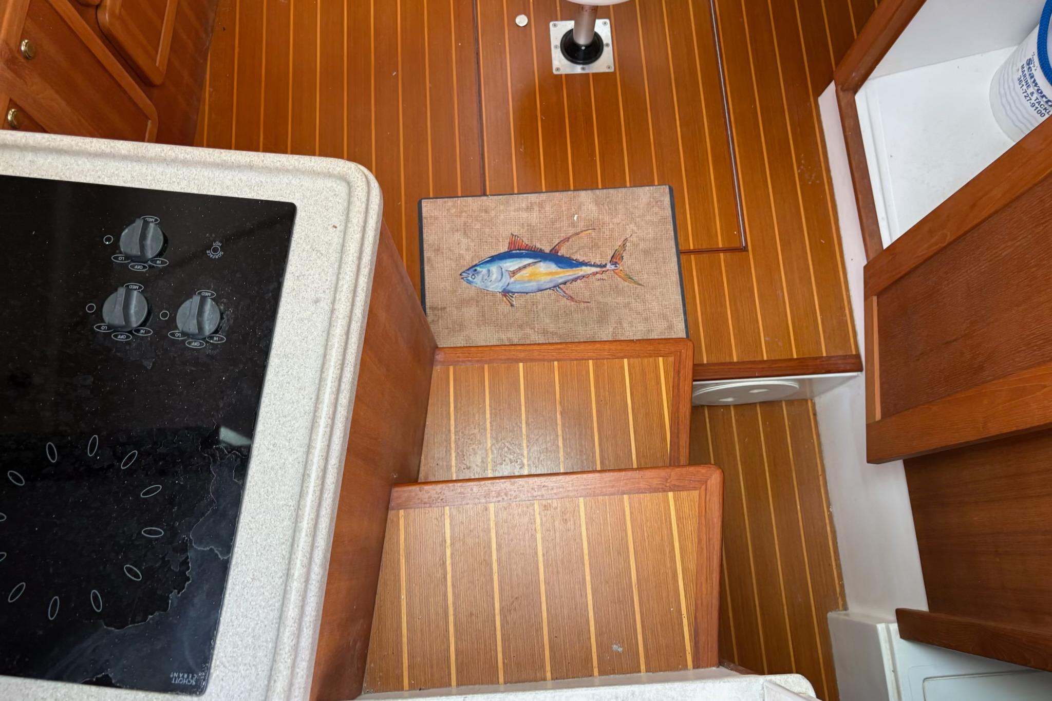 Interior of 2008 Stamas 370 Express with wooden flooring and fish-themed mat.