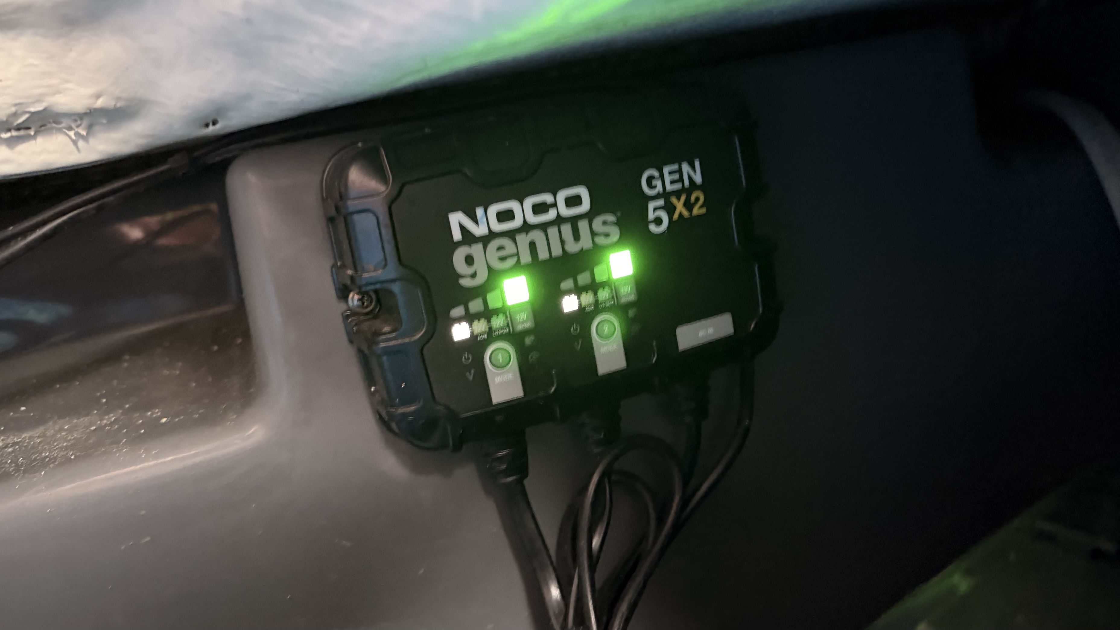 A NOCO Genius GEN 5x2 charger is installed onboard, with glowing indicator lights.