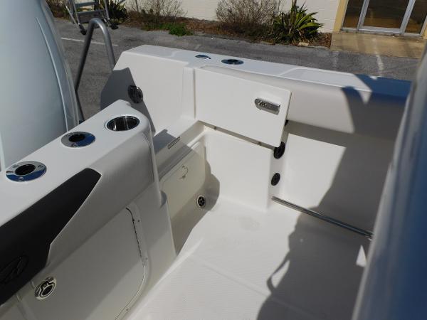 2024 Sailfish 242 CC boat interior, featuring storage compartments and cup holders.
