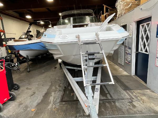 2023 Crownline Eclipse E235 XS boat on trailer in indoor storage.