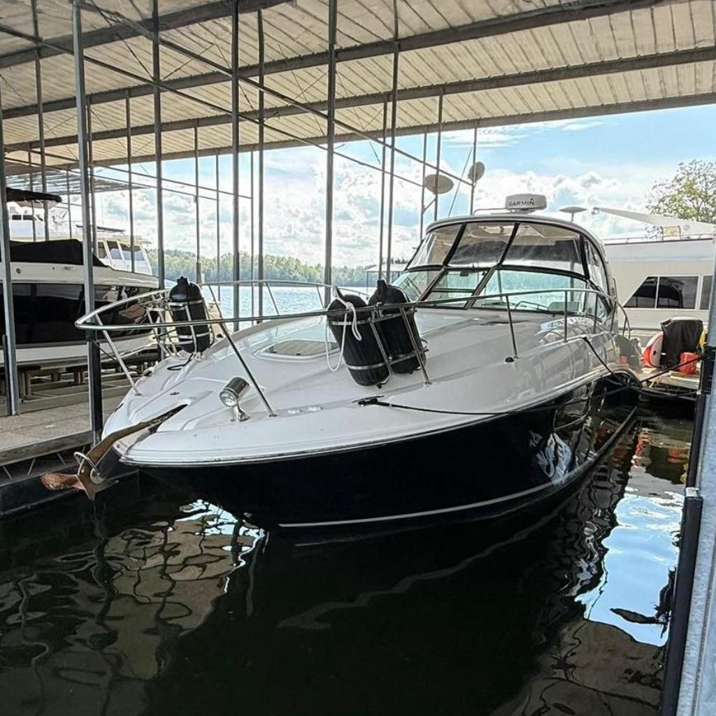2009 Sea Ray 350 Sundancer docked in a marina under a covered structure.