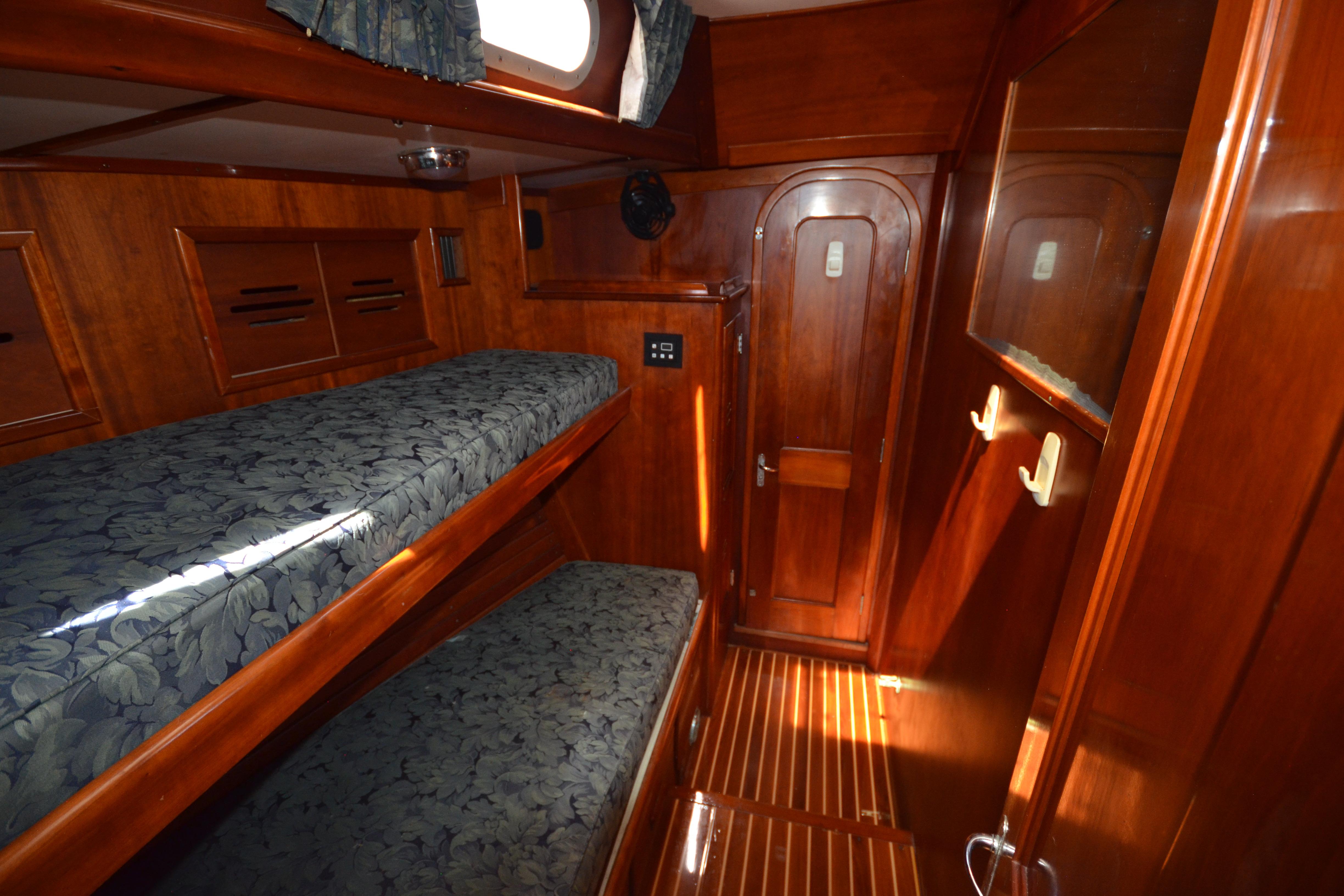 Interior of 1992 Hinckley Sou'wester 59 yacht with wooden bunk beds and cabinetry.