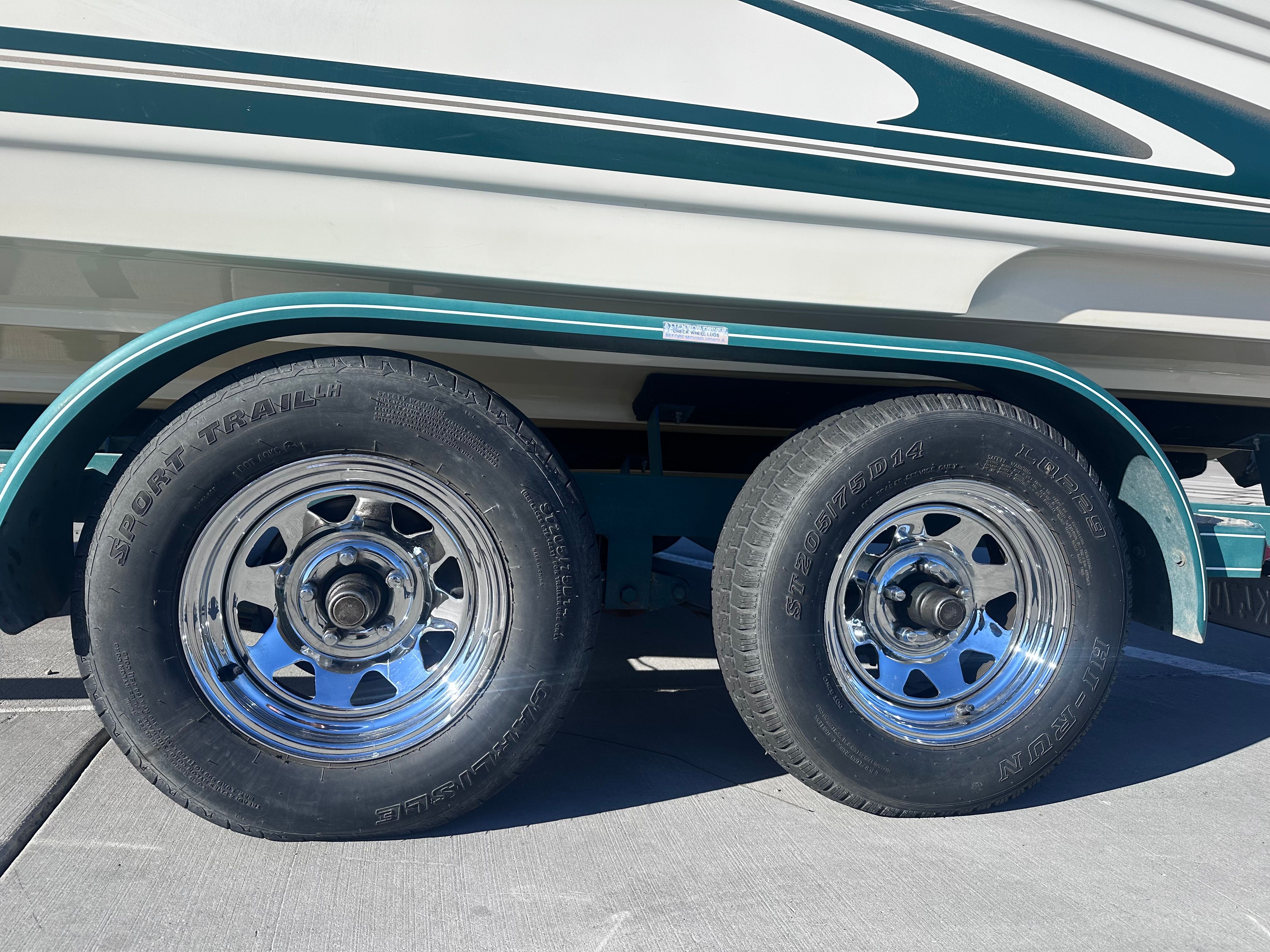 Dual tires of a 2000 Sea Ray Signature Series boat trailer.