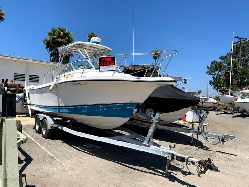A 2003 Bayliner Walk Around Cuddy Cabin boat is on a trailer for sale.