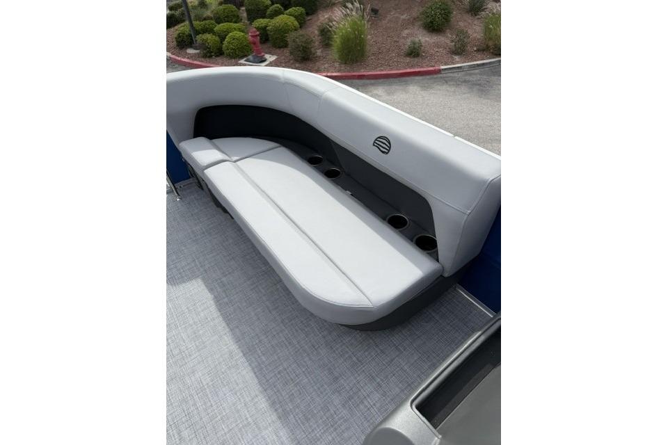 2026 Sun Tracker Party Barge 16 DLX interior seating with cup holders, gray upholstery.