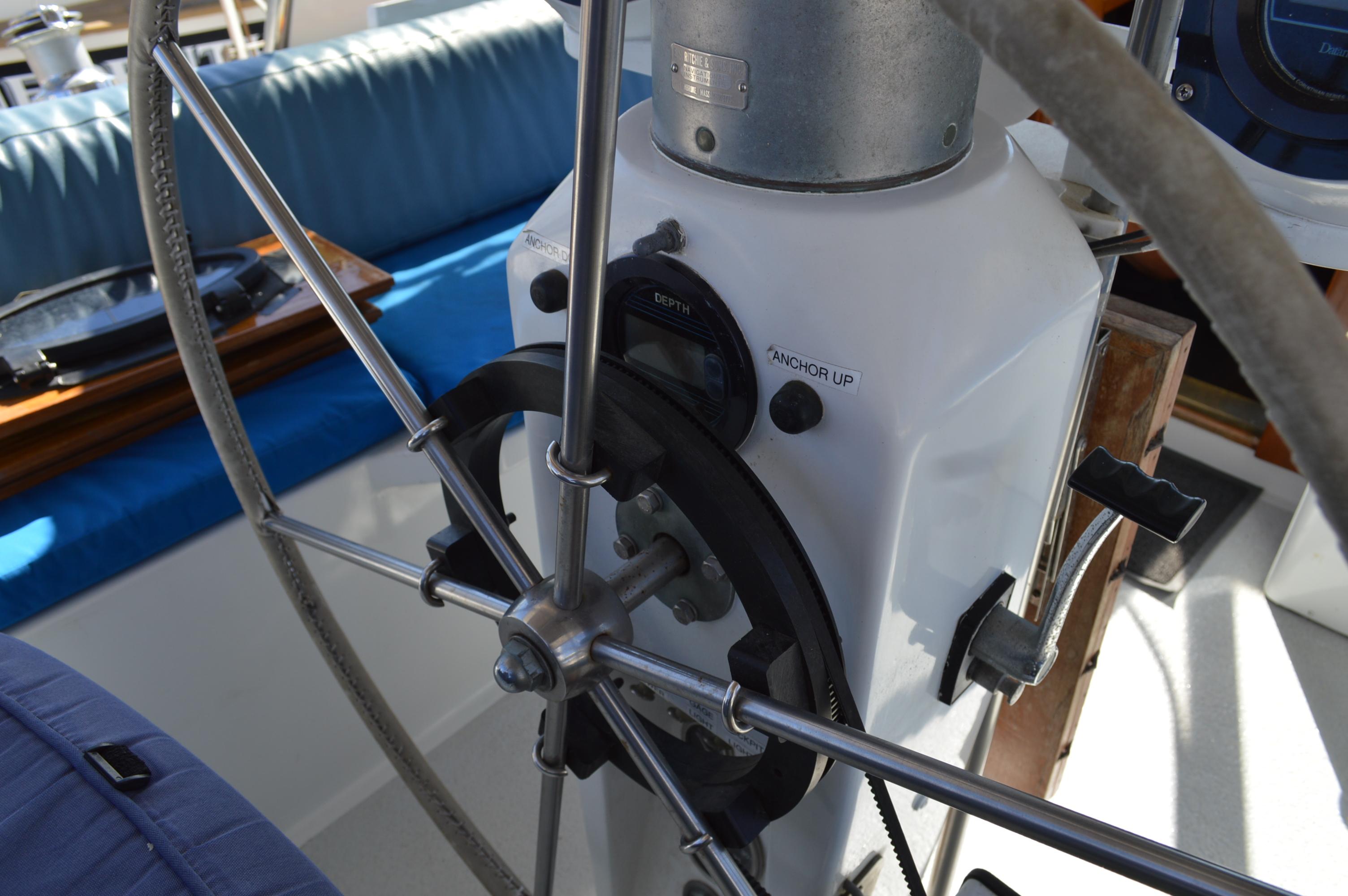 Steering wheel and controls of a 1979 Morgan 461 sailboat, featuring anchor controls.