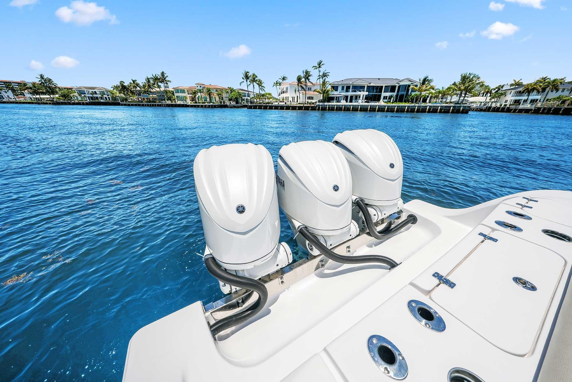 2024 Sportsman Open 352 Center Console with triple engines on blue water.