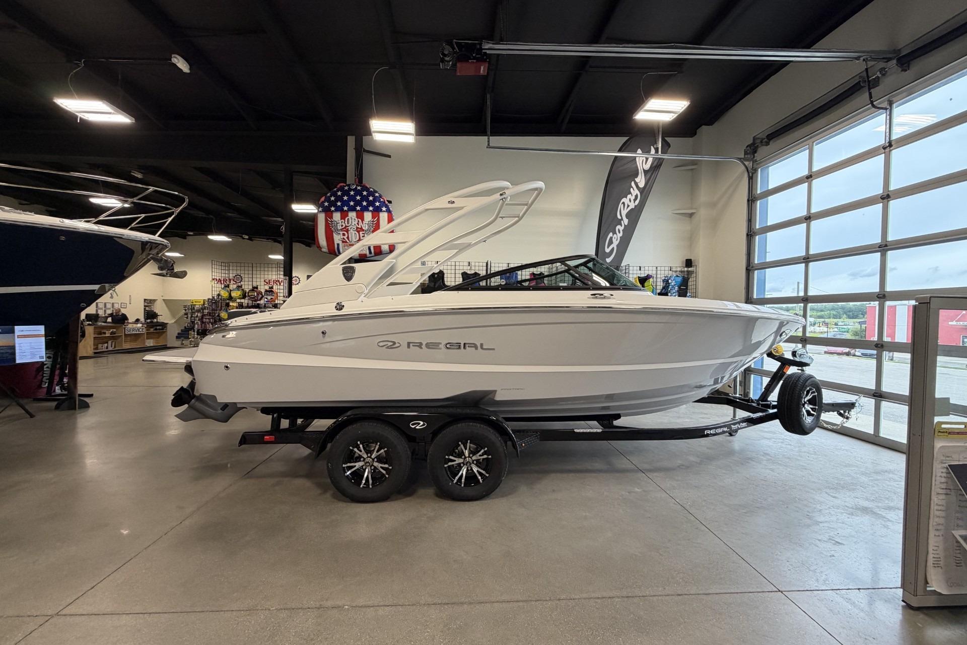 2027 Regal LS2 boat displayed indoors on a trailer, showcasing sleek design and modern features.