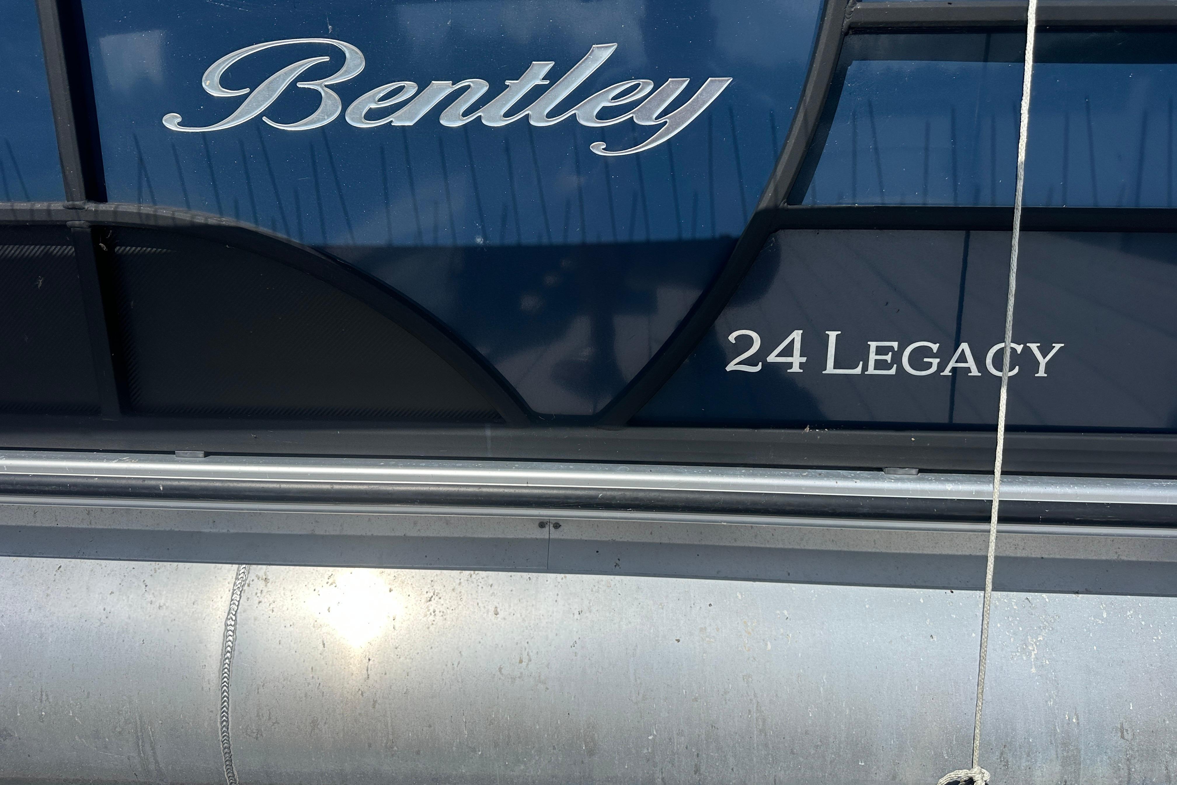 2023 Bentley Pontoons Legacy 243 Swingback, close-up of logo and model name.