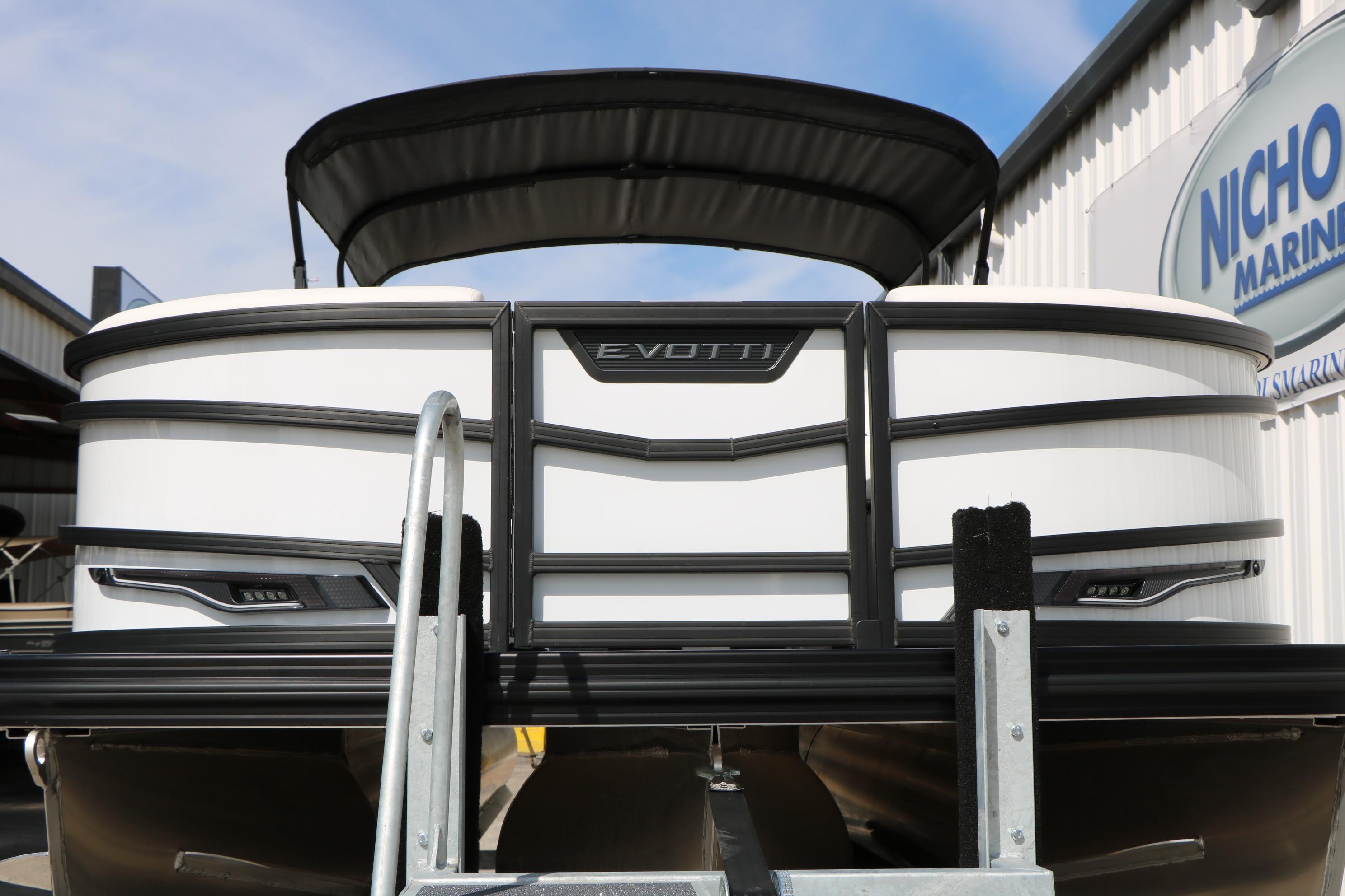 2026 Evotti 725 CS Tri-Toon boat at marina, showcasing sleek design and modern features.