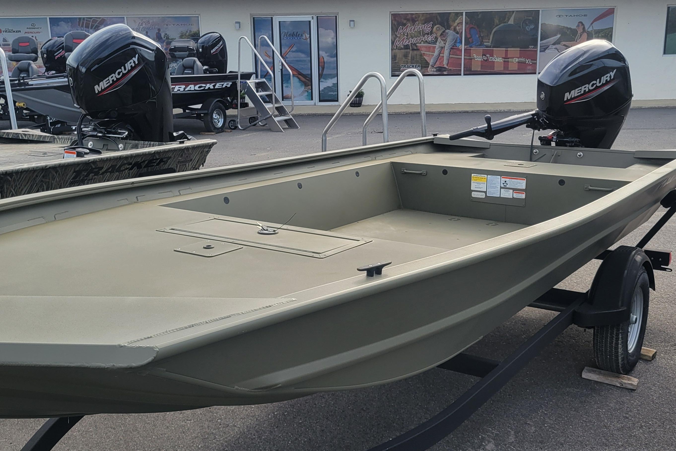 2026 Tracker Grizzly 1754 Utility boat with Mercury outboard motor, displayed outdoors.
