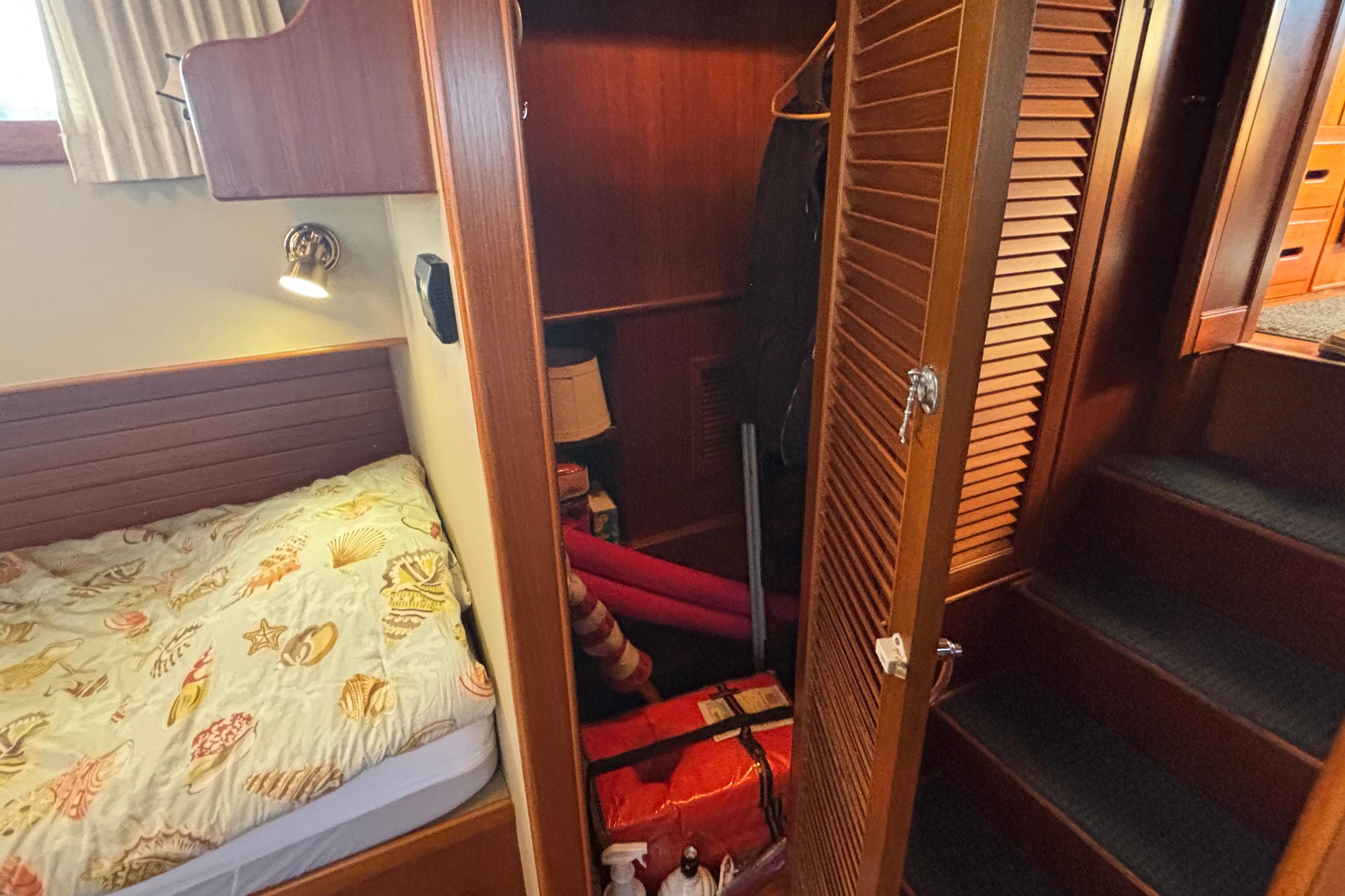 Cozy cabin interior of 1989 Grand Banks 46 Classic with bed and closet.