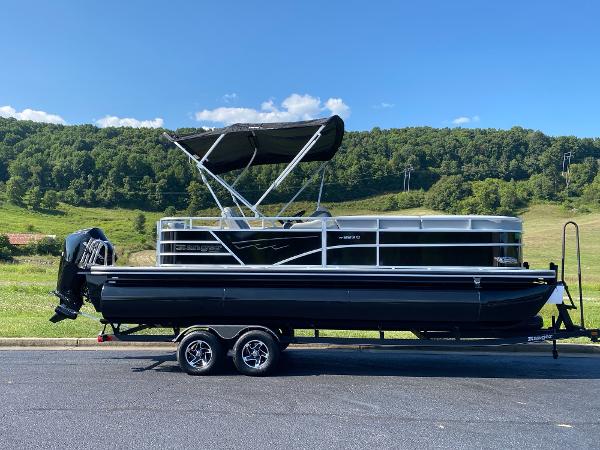 2024 Ranger Reata 223C pontoon boat on trailer, parked in scenic outdoor setting.