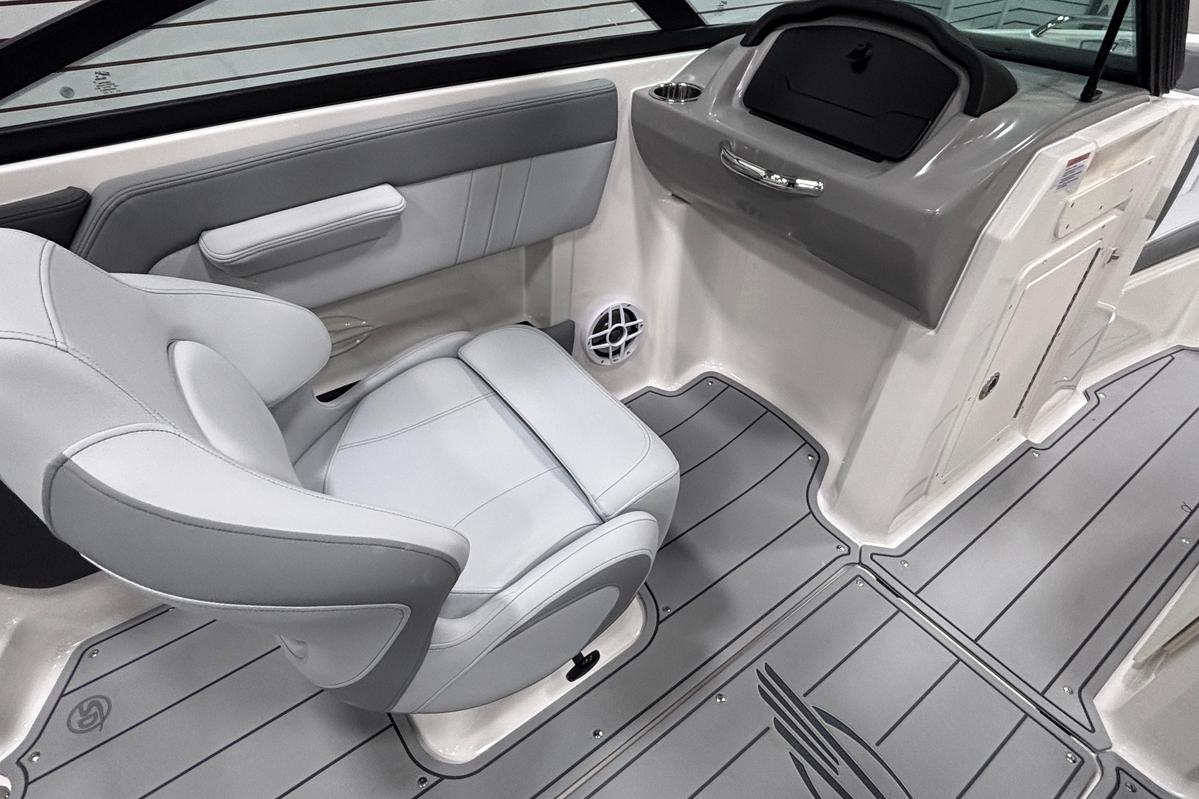 2026 Chaparral 21 SSi boat interior with gray seating and sleek dashboard design.