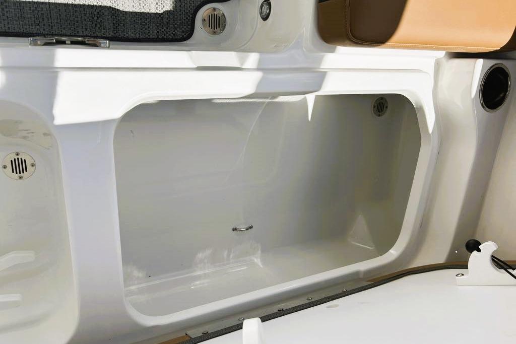 2026 Tahoe 2150 boat storage compartment with white interior and seating area.