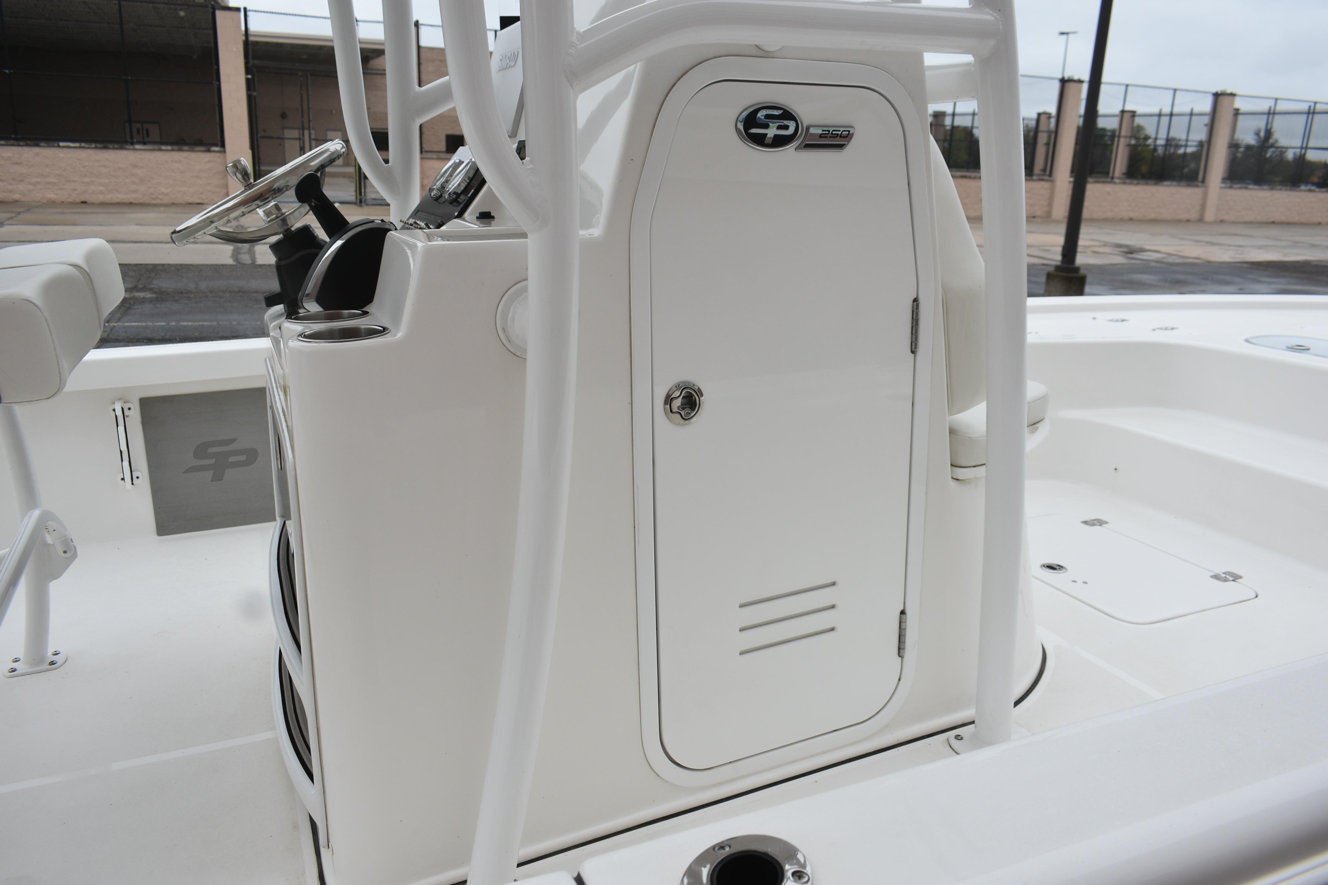 2025 Sea Pro 250 Bay boat console with steering wheel and storage compartment.