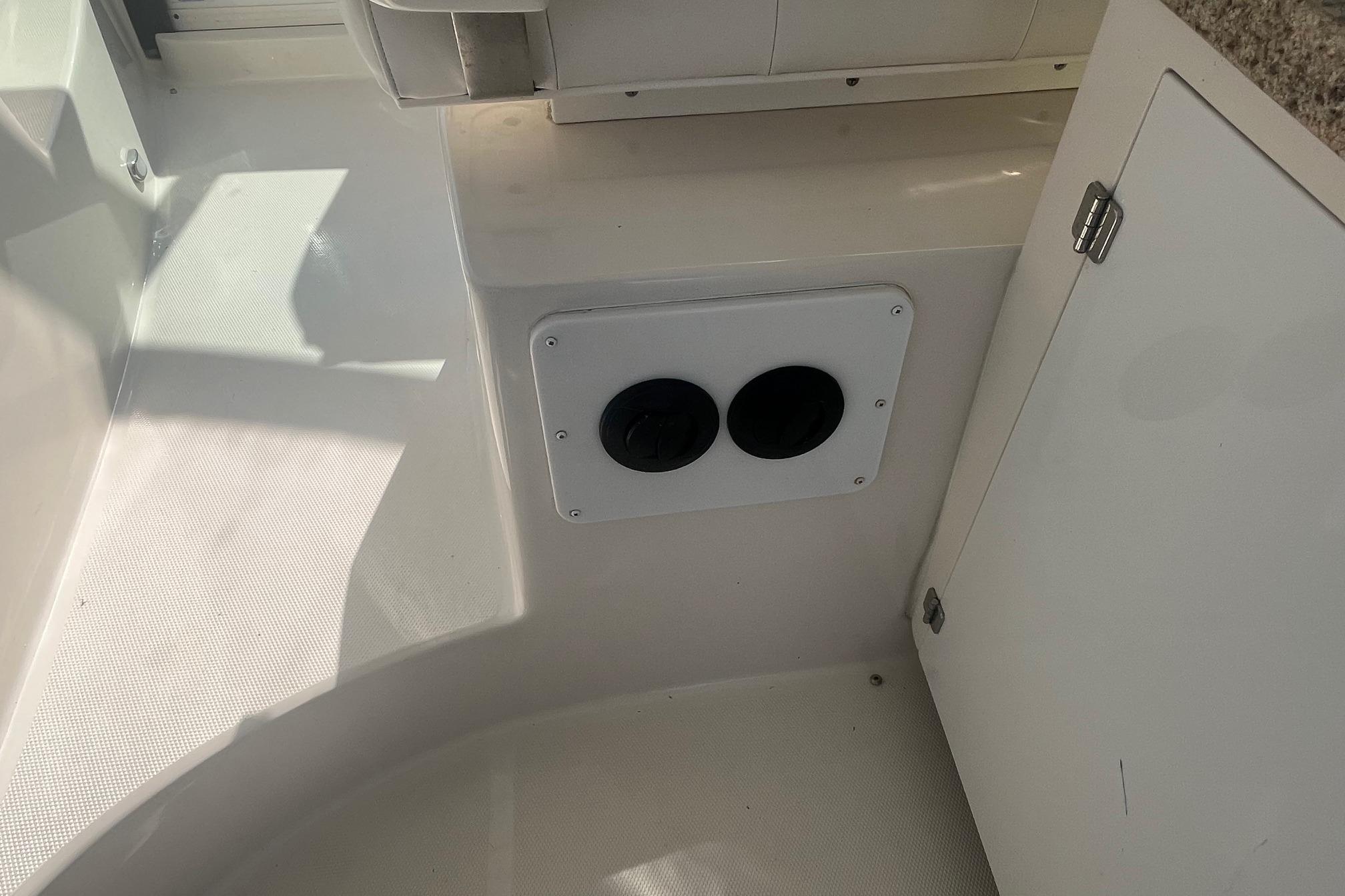 Interior of 2010 Monterey 400 Sport Yacht showing storage compartment and cup holders.