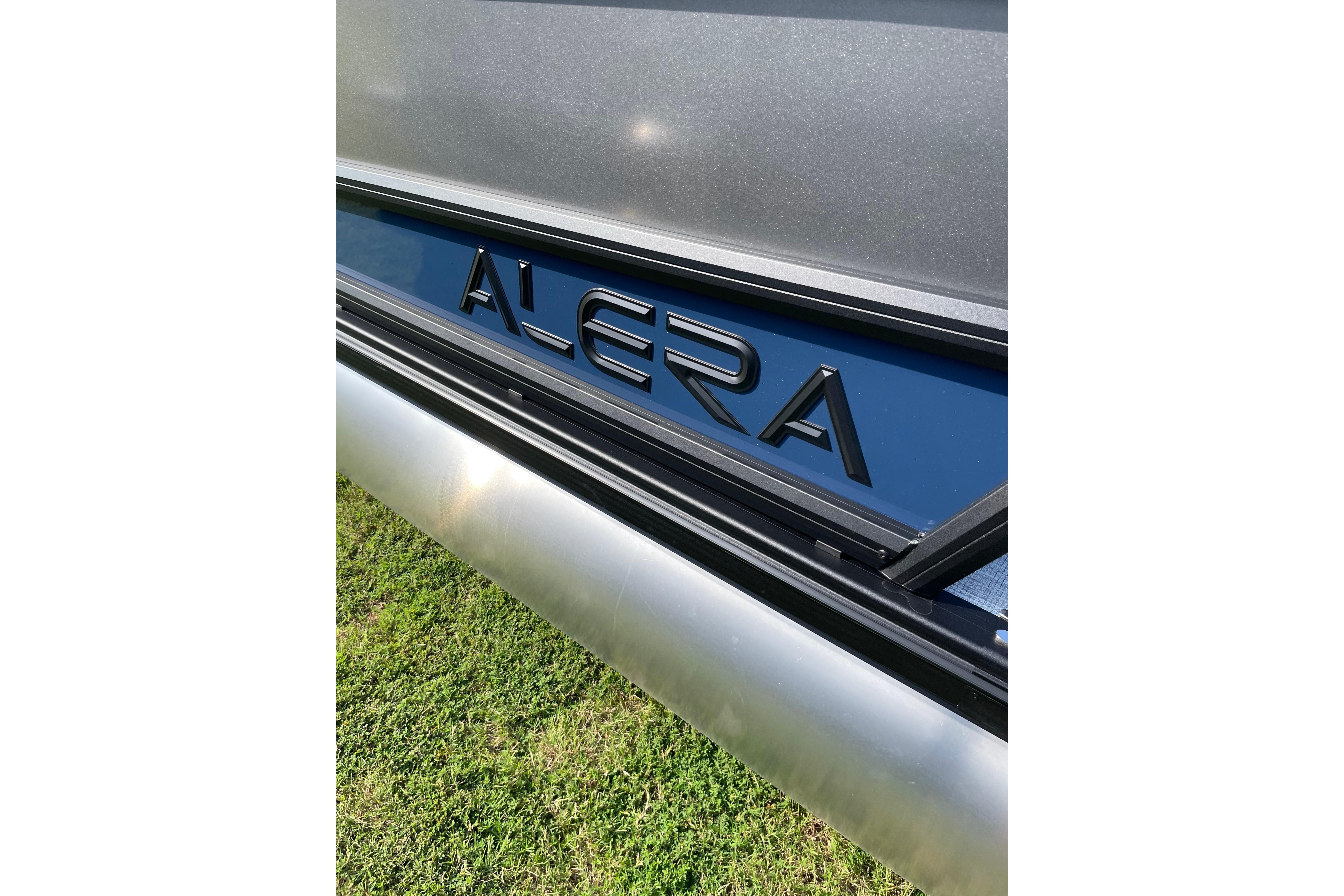 2027 Alera a24 logo on sleek metallic surface, outdoor setting.