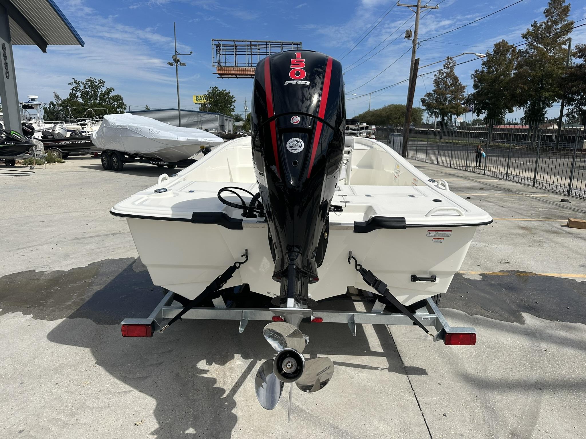 2024 Mako Pro Skiff 19 CC boat with outboard motor on trailer.