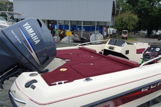 1996 Quantum 180 XD boat with Yamaha outboard motor, red interior, docked near a shed.