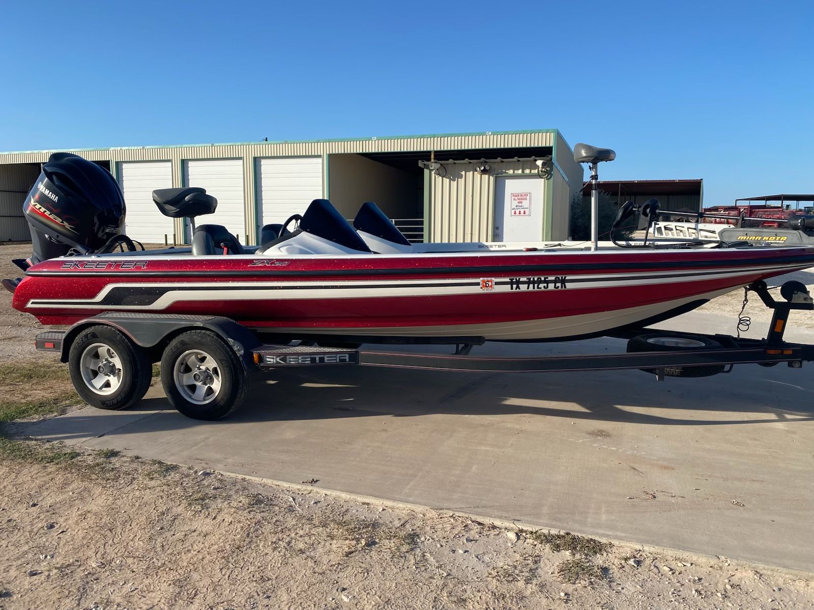 2012 Skeeter ZX20 boat on trailer in front of storage building.
