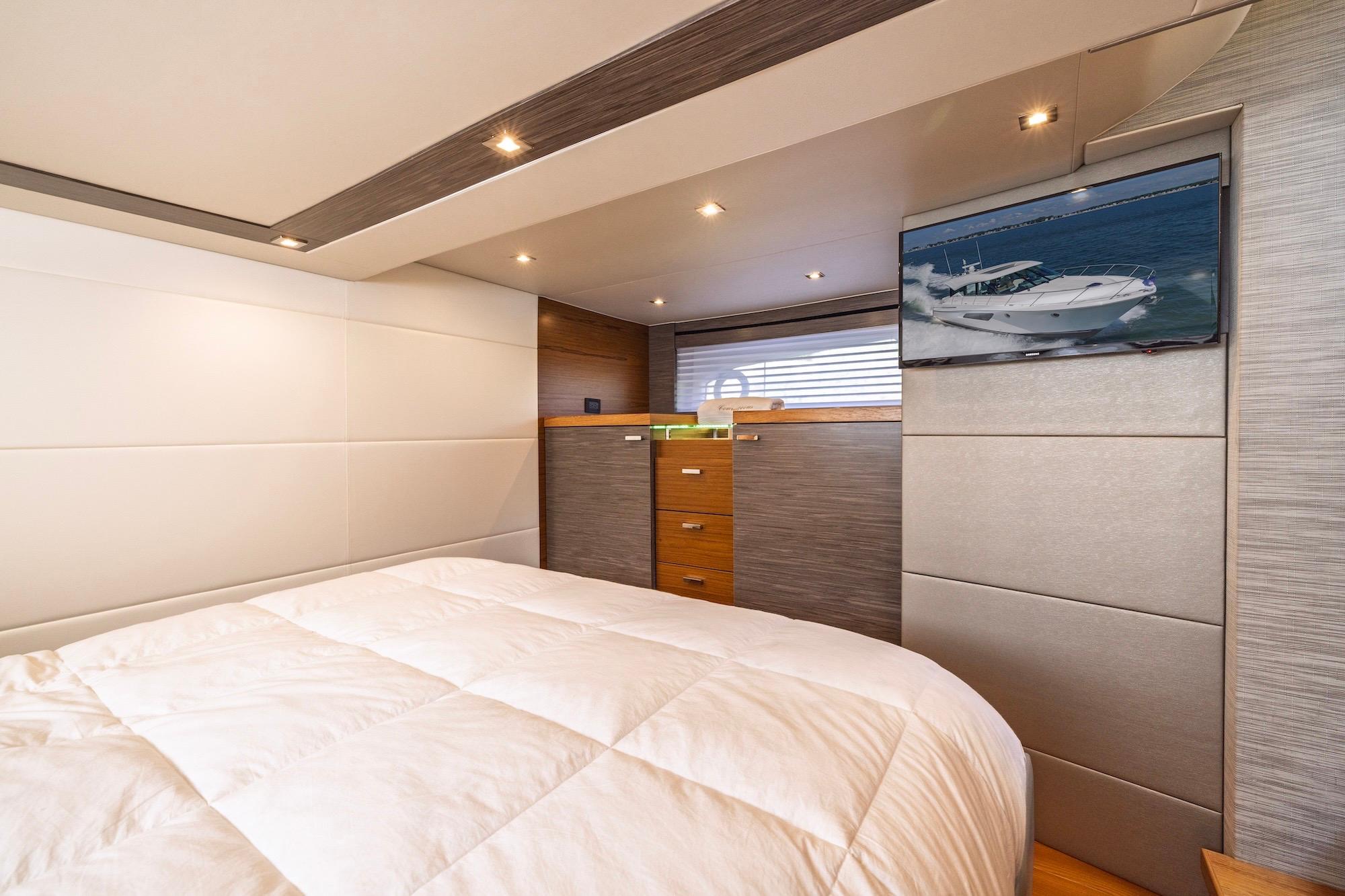 Luxurious bedroom interior of 2020 Tiara Yachts C53 Coupe with modern design and TV.