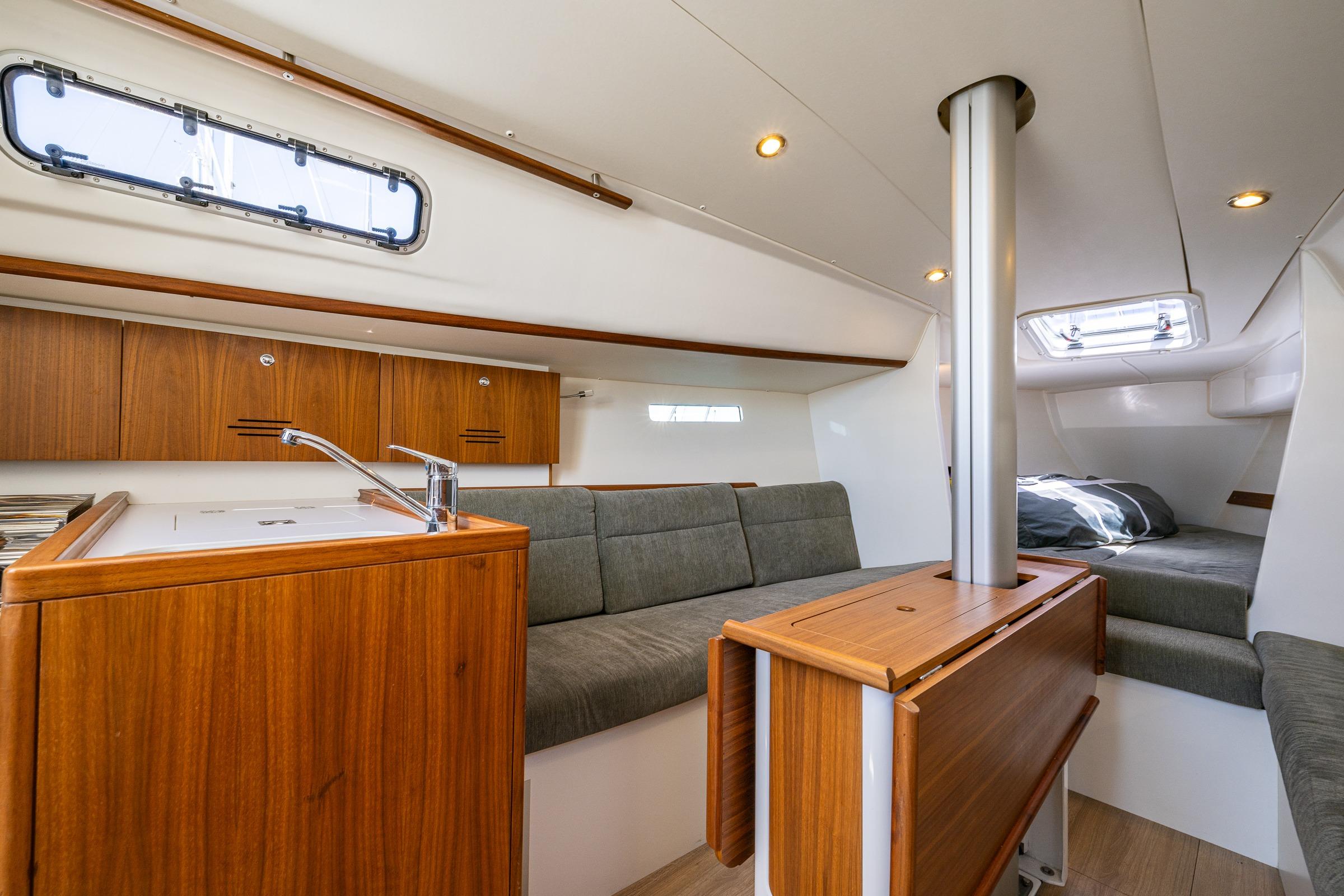 Interior of 2018 J Boats J/97E sailboat with wood finish and cozy seating area.