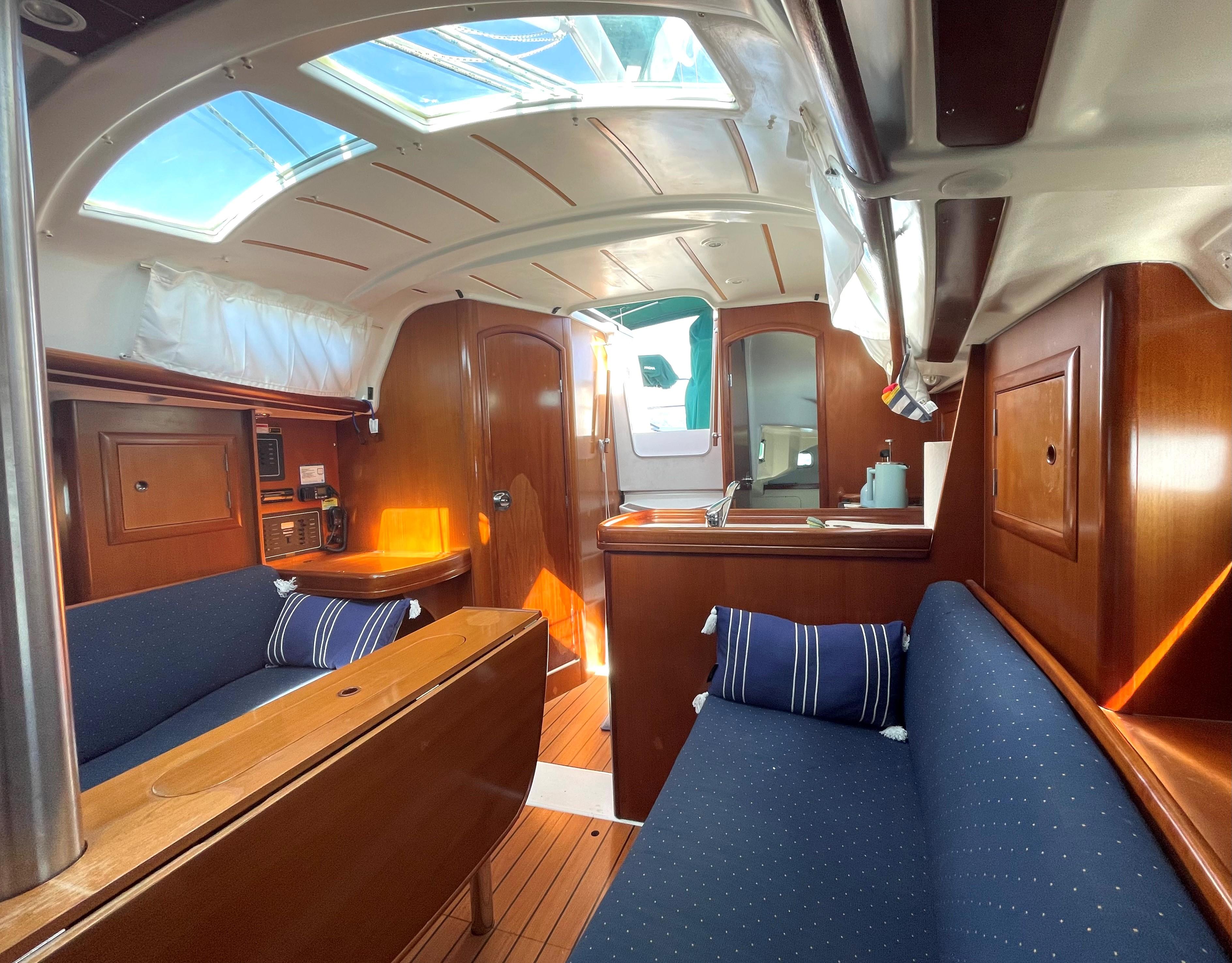 Interior of a 2005 Beneteau 323 yacht with wooden furnishings.