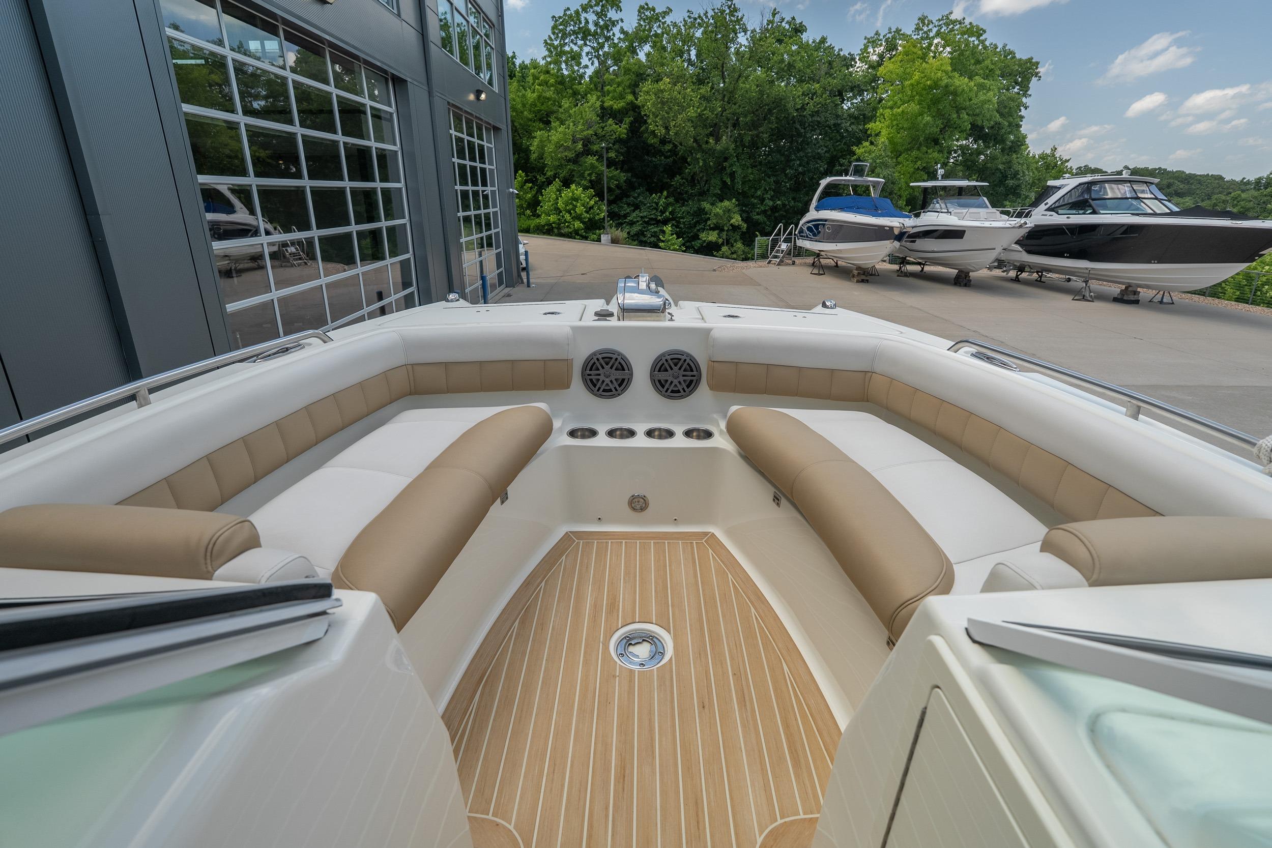 2016 World Cat Glacier Bay Edition 2740 Dual Console boat interior with beige seating and wood flooring.