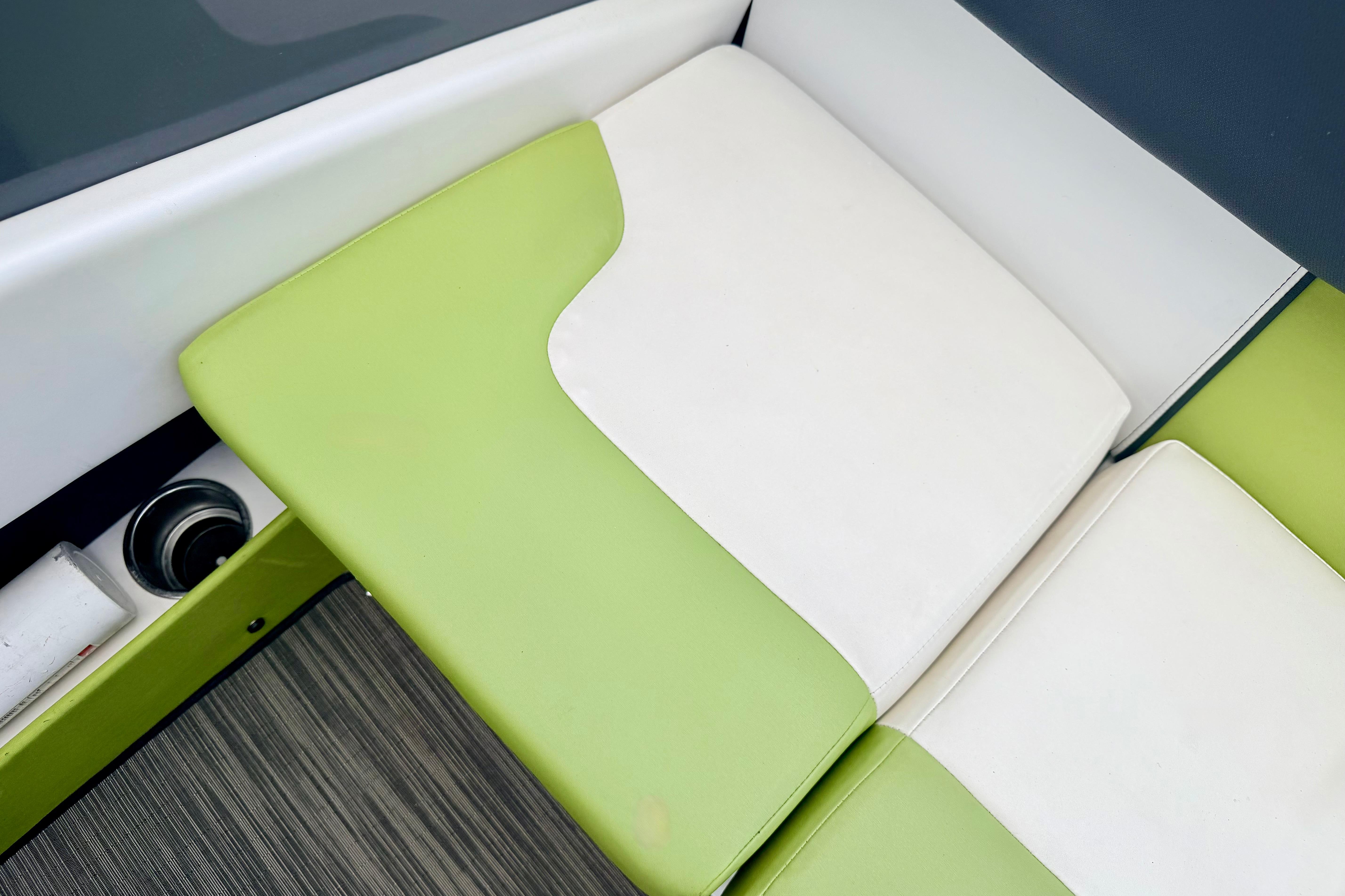 Green and white seating on 2018 Glastron GT 185 boat interior.