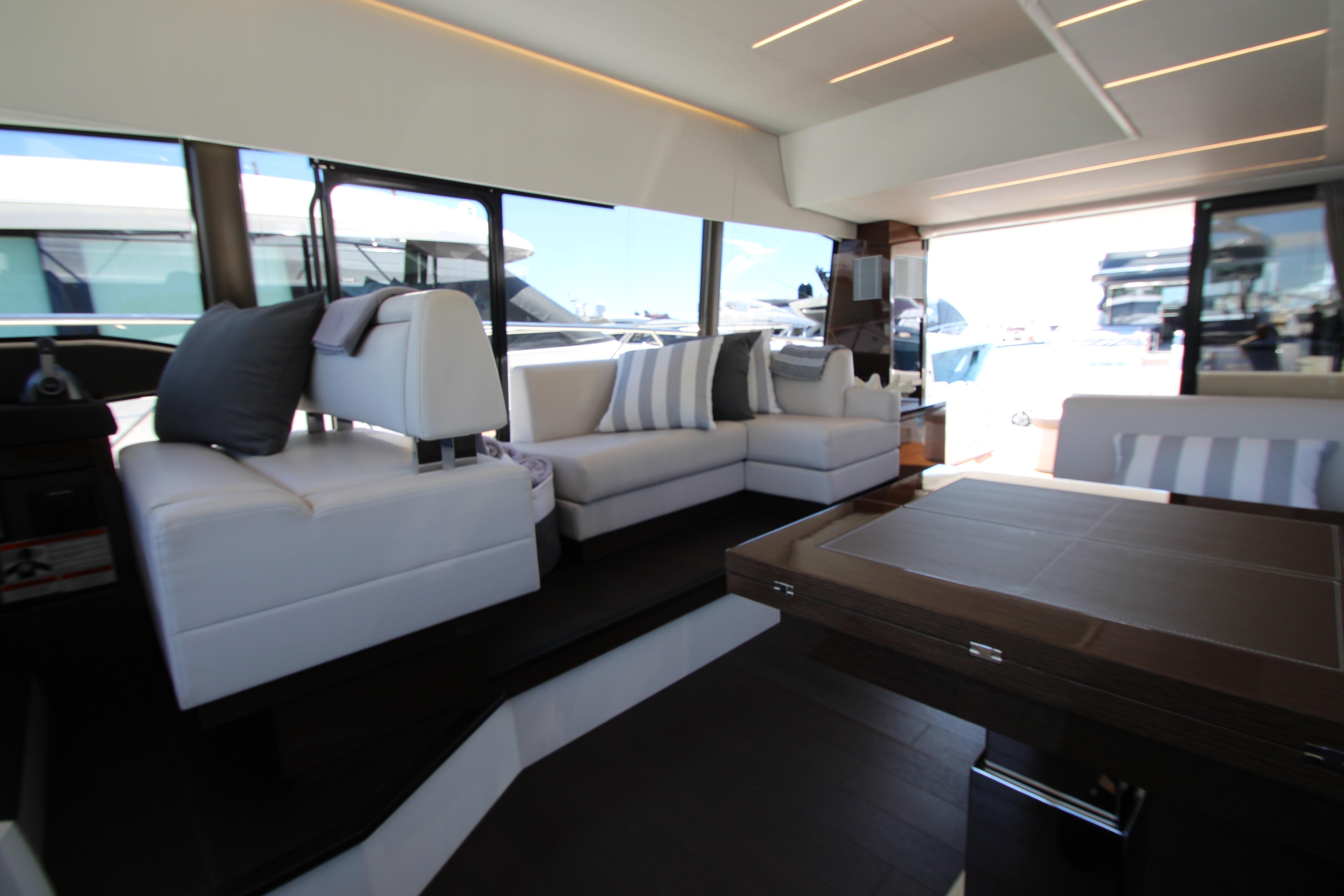 Luxurious interior of 2022 Prestige 520 yacht with modern seating and elegant decor.