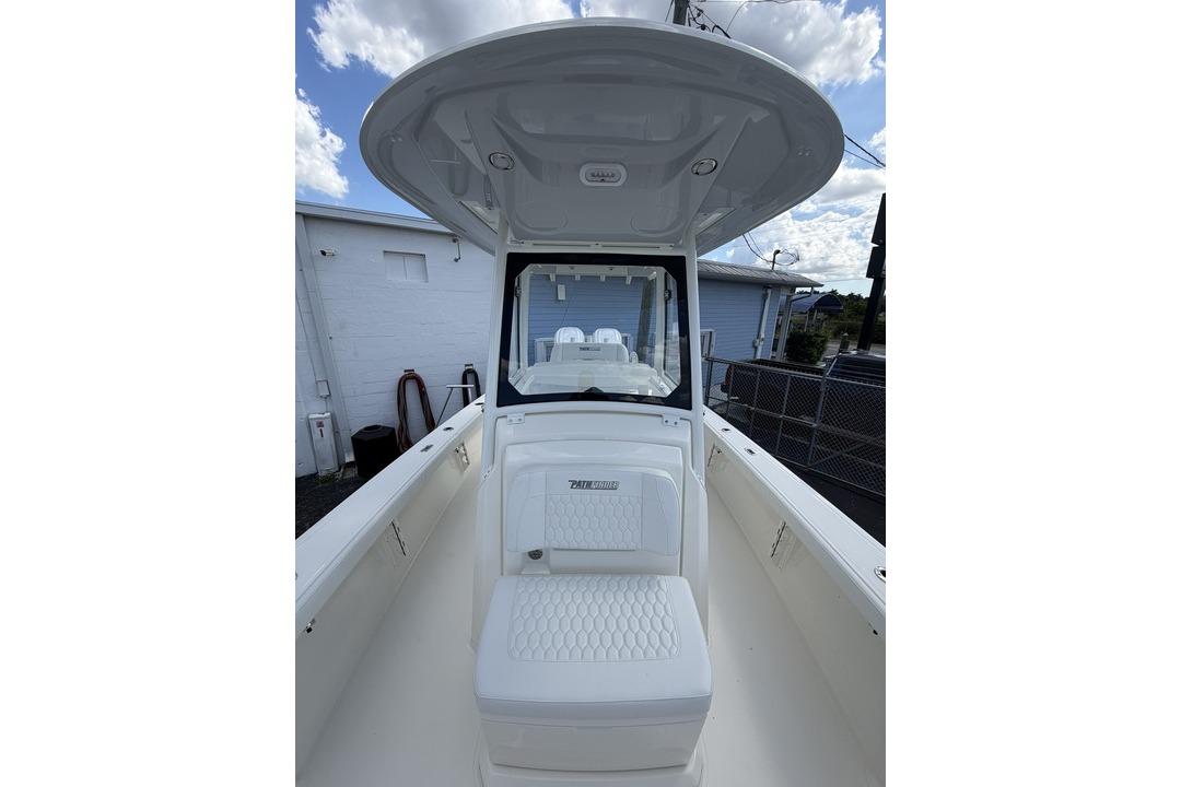 2026 Pathfinder 2800 Hybrid boat interior with seating and console under a clear sky.