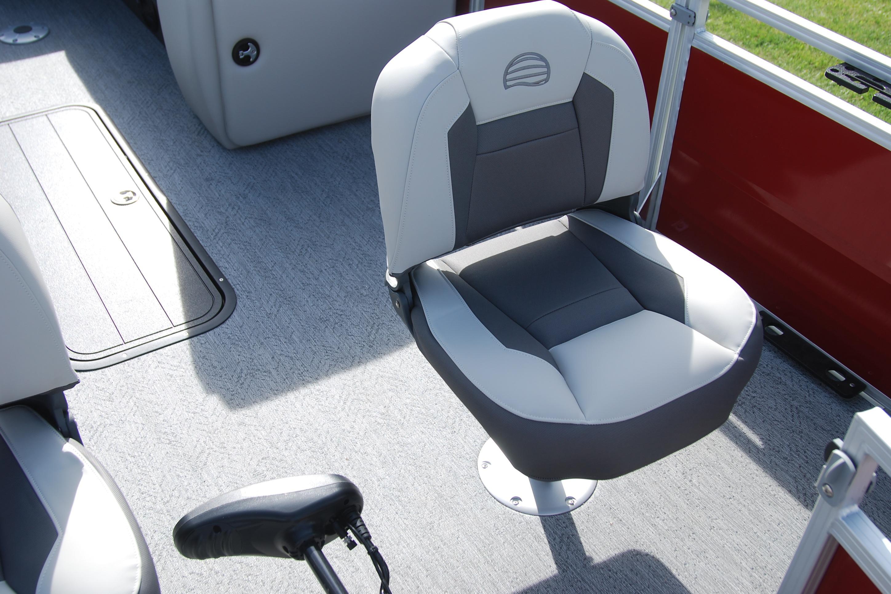 2026 Sun Tracker Fishin' Barge 22 XP3 boat seat, gray and white upholstery, red panel background.