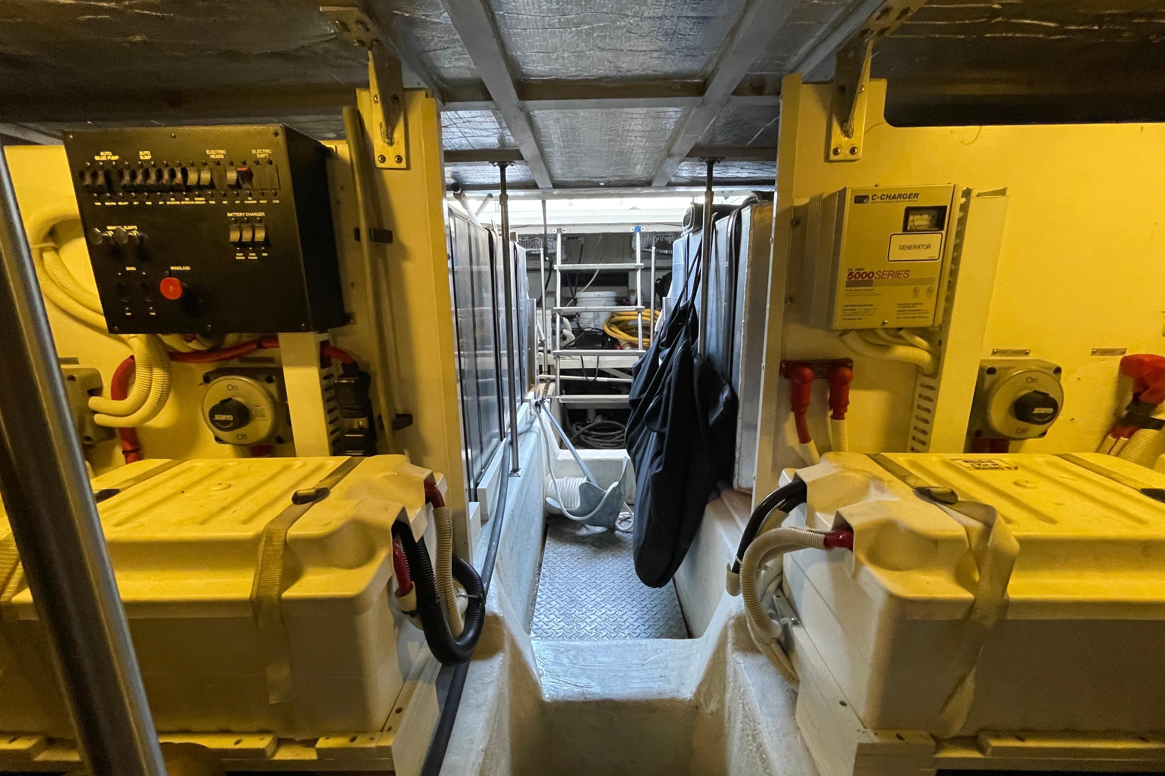 Engine room of 2002 Carver 570 Voyager Pilothouse with control panels and equipment.