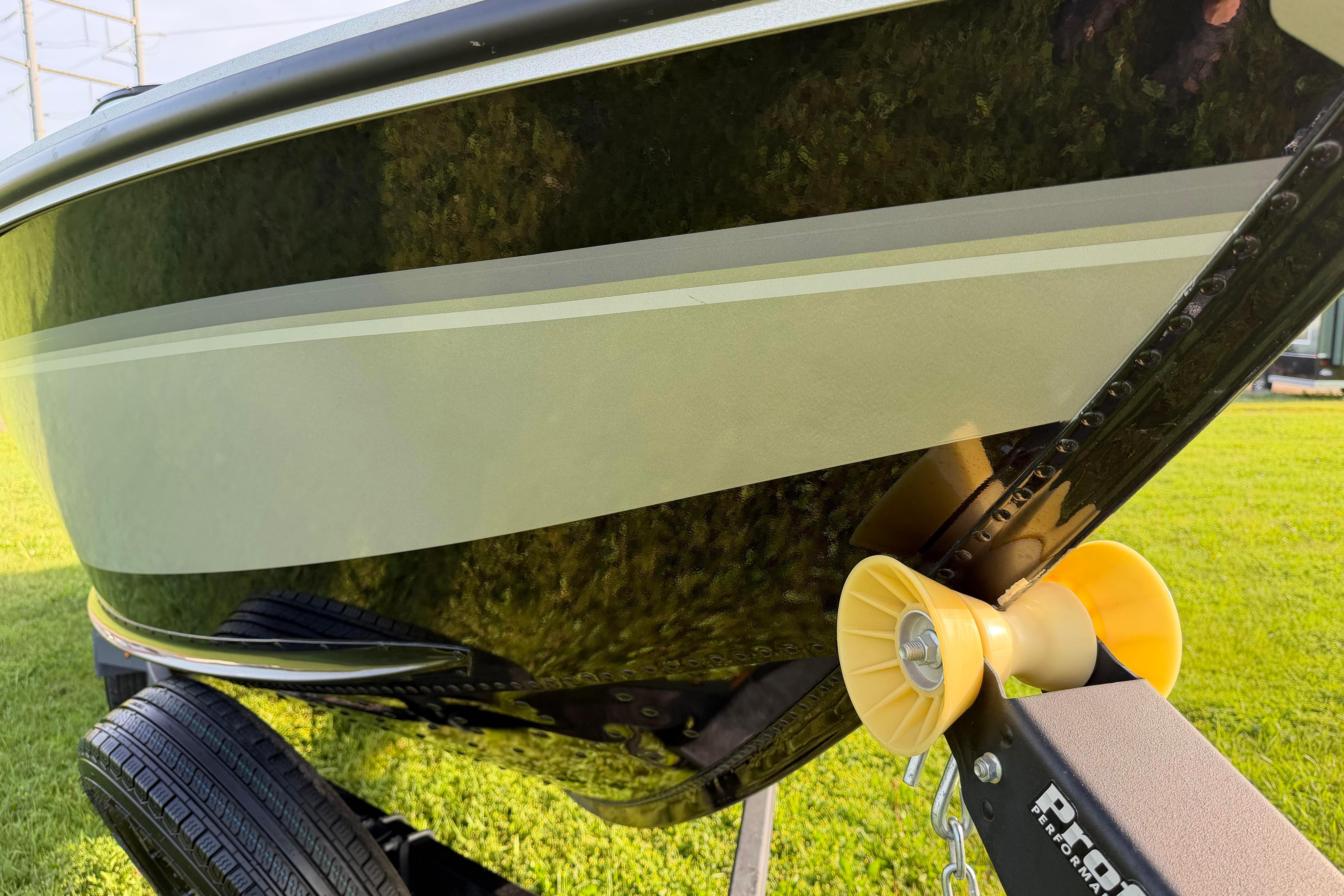 2019 Alumacraft Trophy 205 boat on trailer, close-up view of hull and roller.