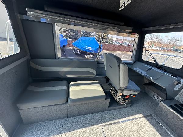 Interior of 2024 Spartan 260 Maximus Pro XL boat with seating and windows.