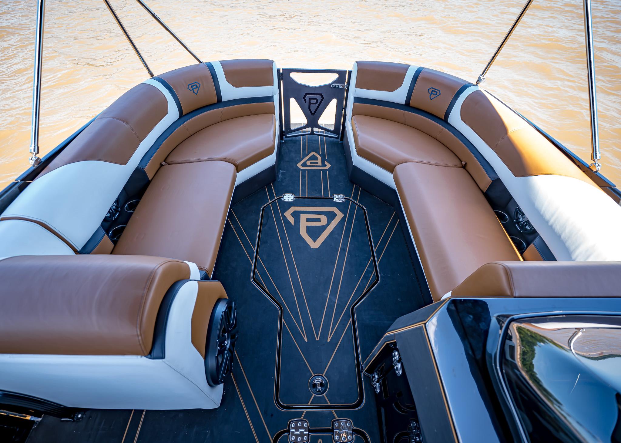 Luxurious Paradigm 236 boat interior with brown and white seating, 2025 model.